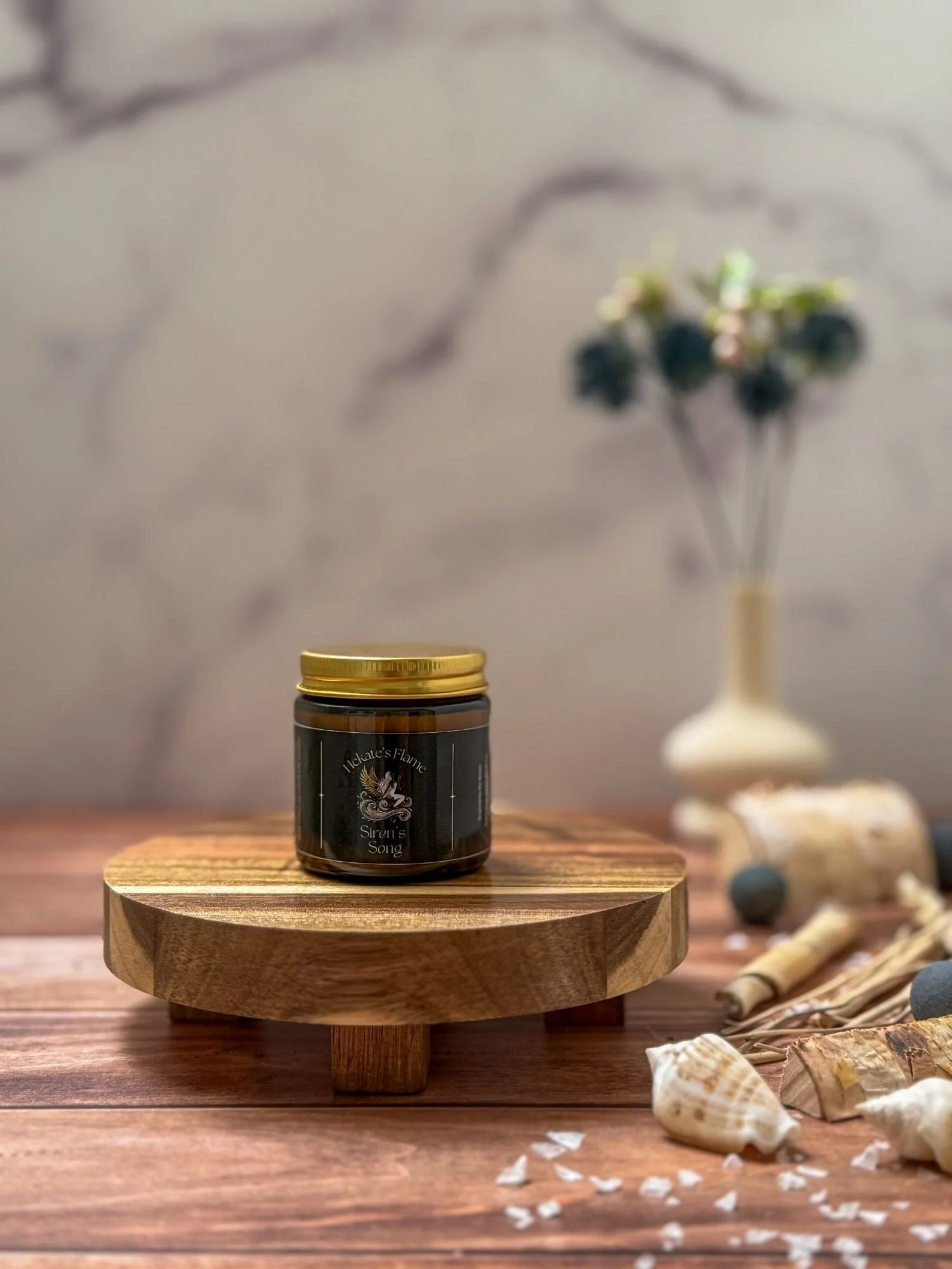 Small handcrafted Siren’s Song myth-inspired candle in amber jar with gold metal lid, coconut apricot wax blend.
