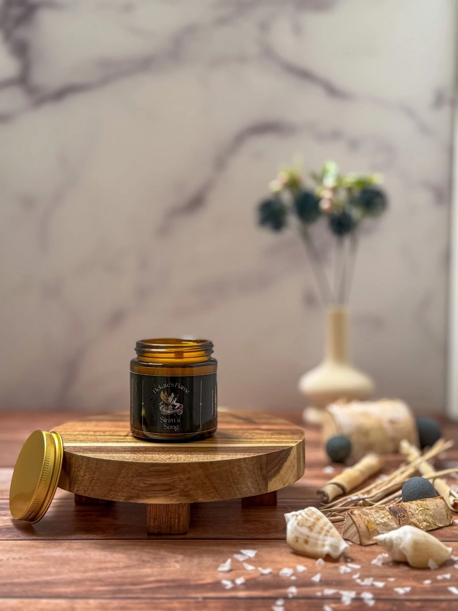 Small handcrafted Siren’s Song myth-inspired candle in amber jar with gold metal lid, coconut apricot wax blend.