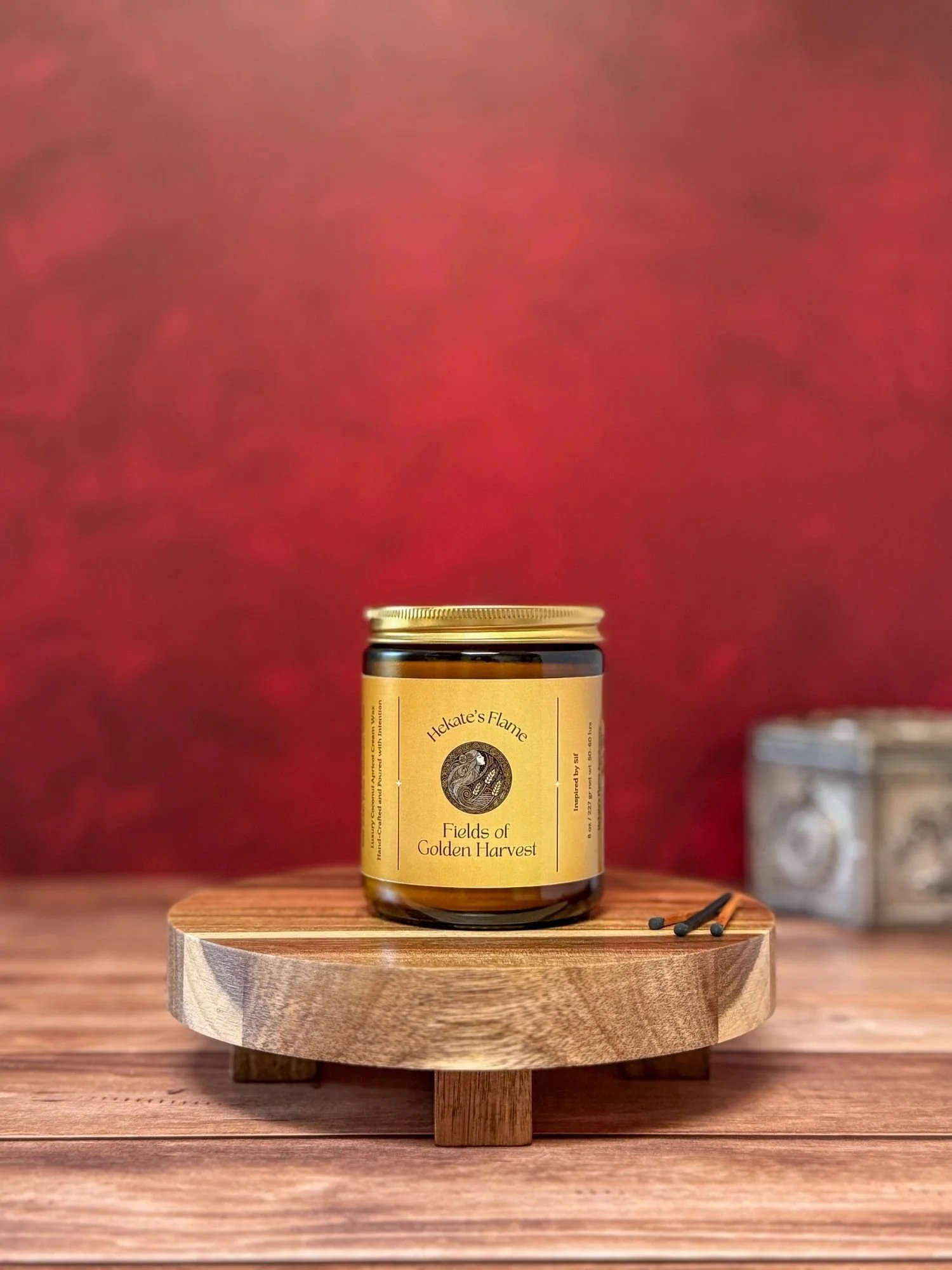 Amber glass jar with gold metal lid, Norse mythology Sif candle, handcrafted coconut apricot wax, eco-conscious luxury candle.