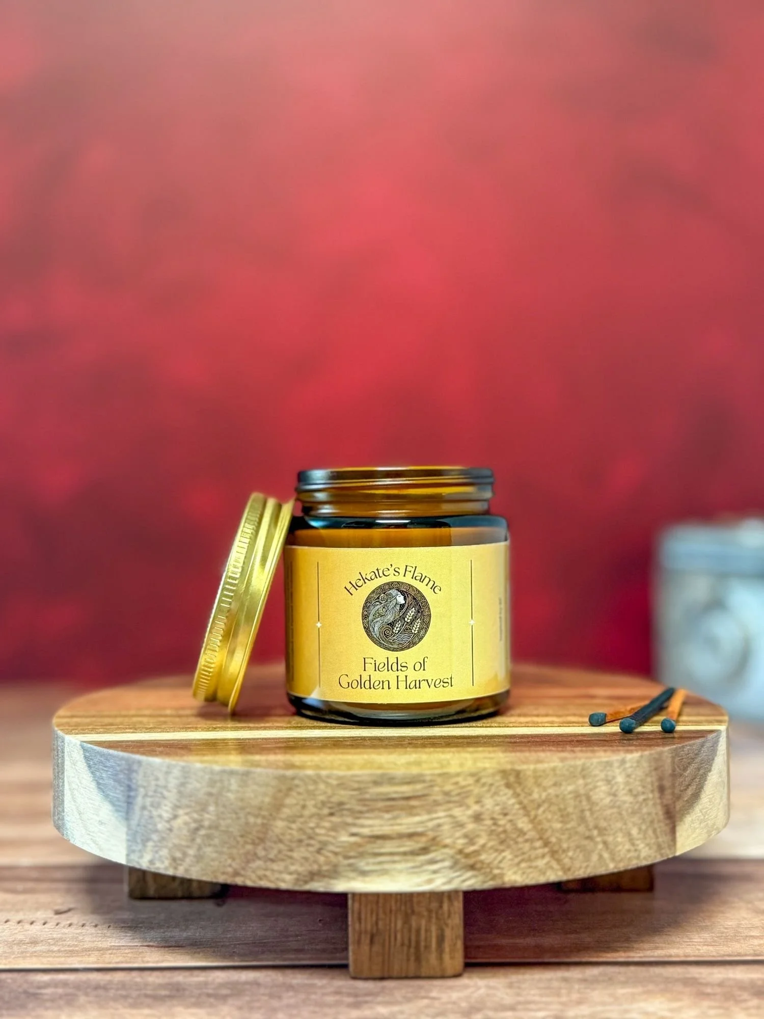 Open amber glass Sif candle with gold lid – luxury goddess candle, sustainable coconut apricot wax blend.