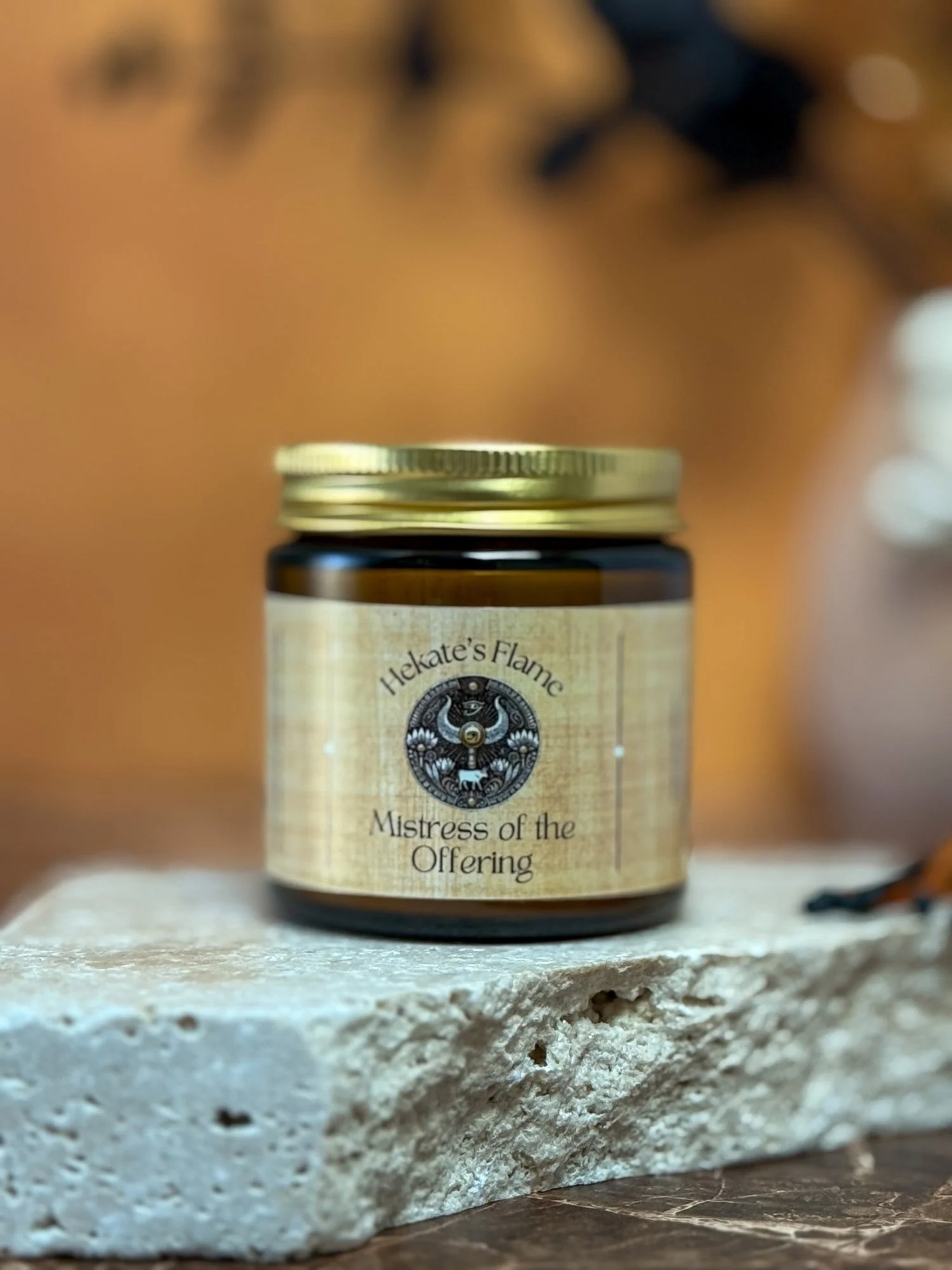 Small amber jar Egyptian mythology candle with gold lid, Hathor-inspired handmade coconut apricot wax, luxury eco-conscious candle.