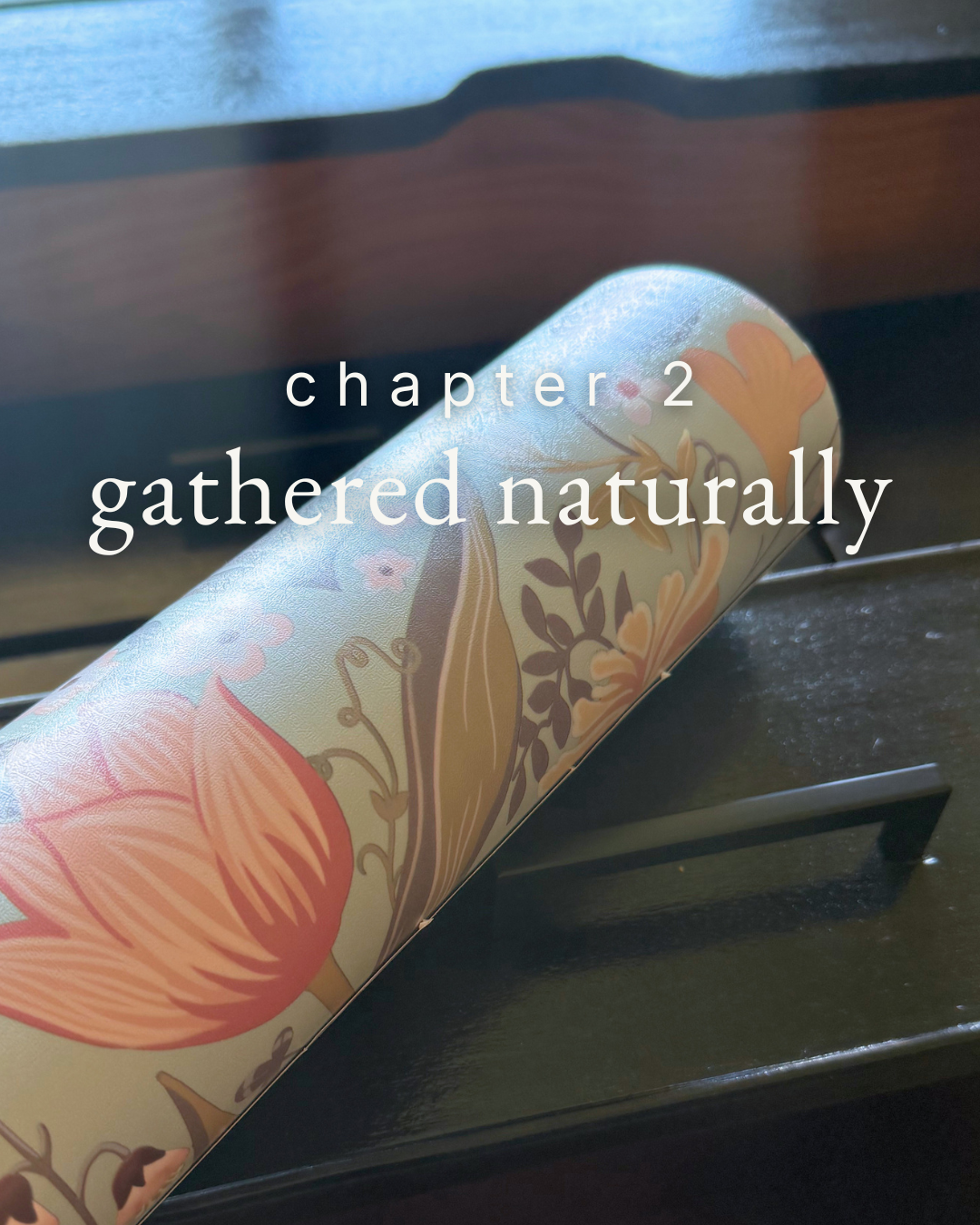 roll of botanical wallpaper with chapter 2 title “gathered naturally” overlaid