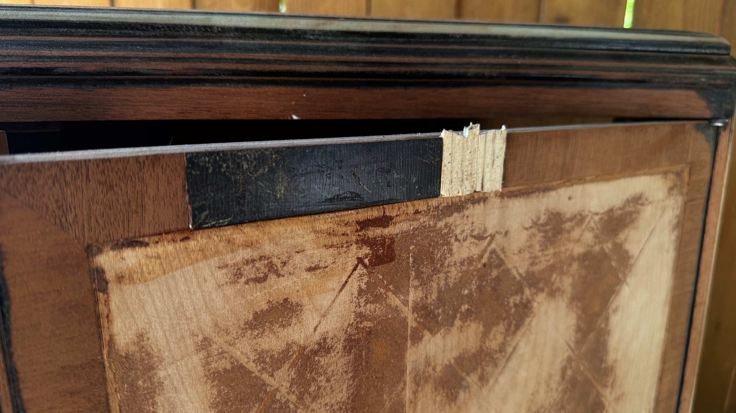 back of a vintage cabinet showing its worn original construction and materials