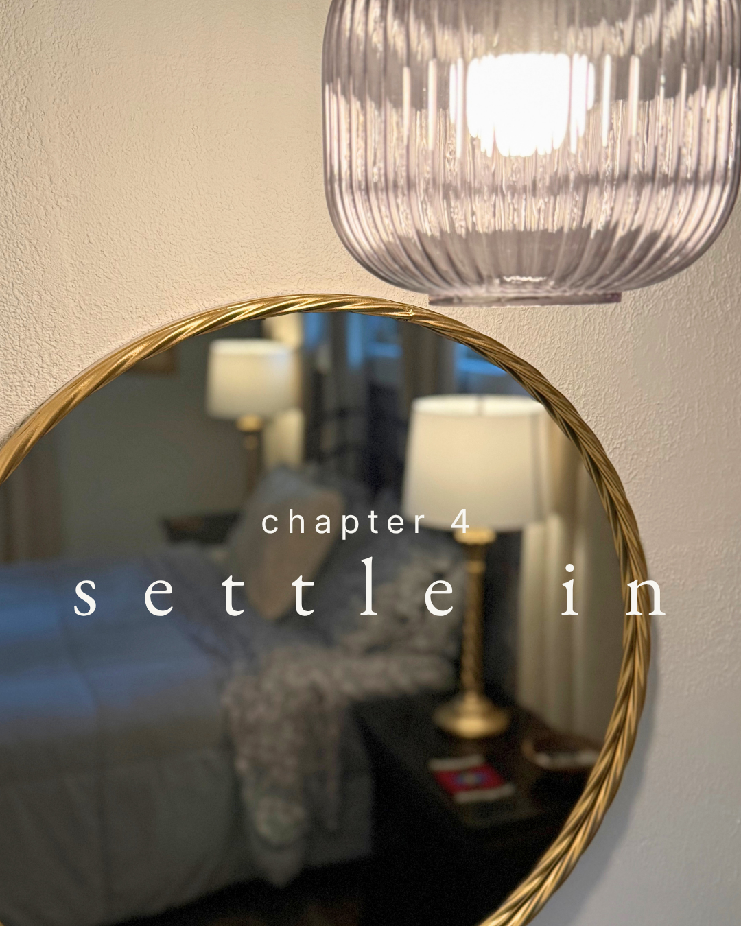 guest room vanity with round mirror and hanging light