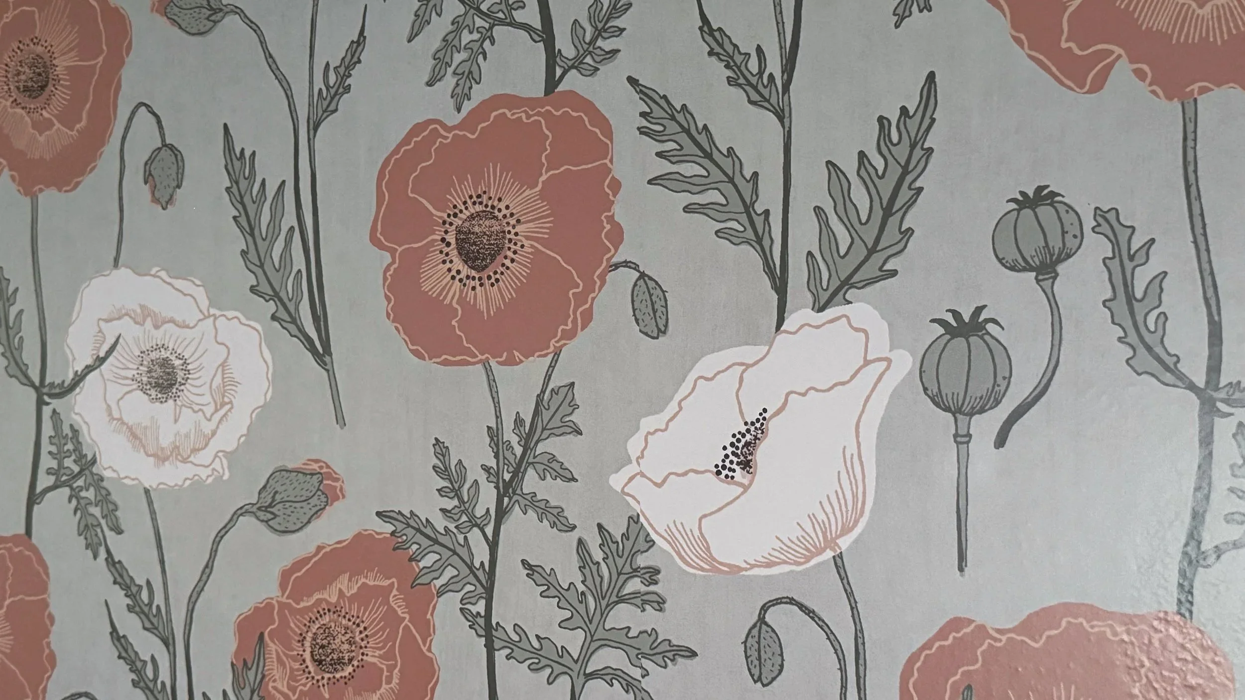 close-up of botanical wallpaper with pink poppies and leafy stems