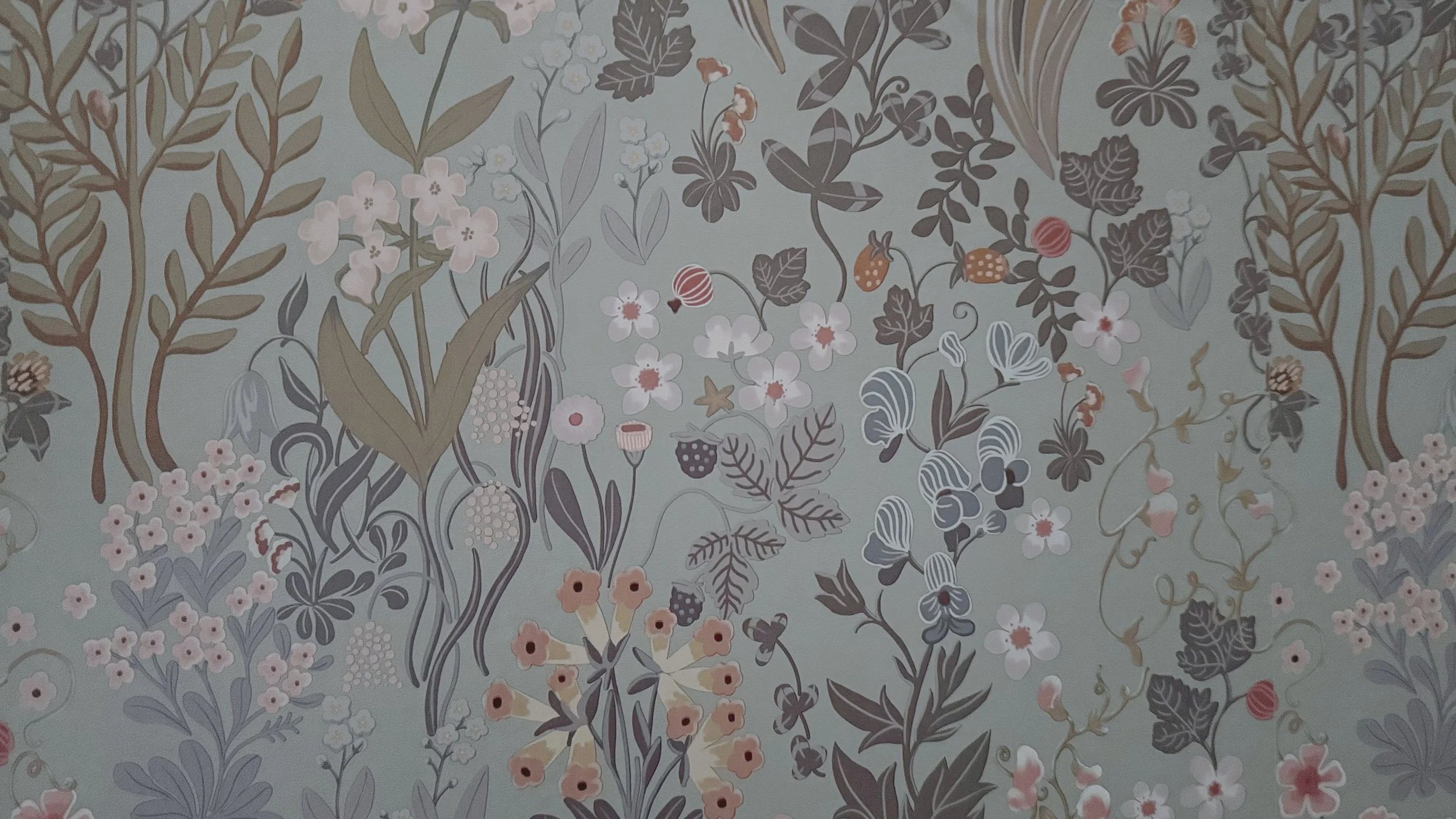 close-up of botanical wallpaper with birds, flowers, and leafy branches