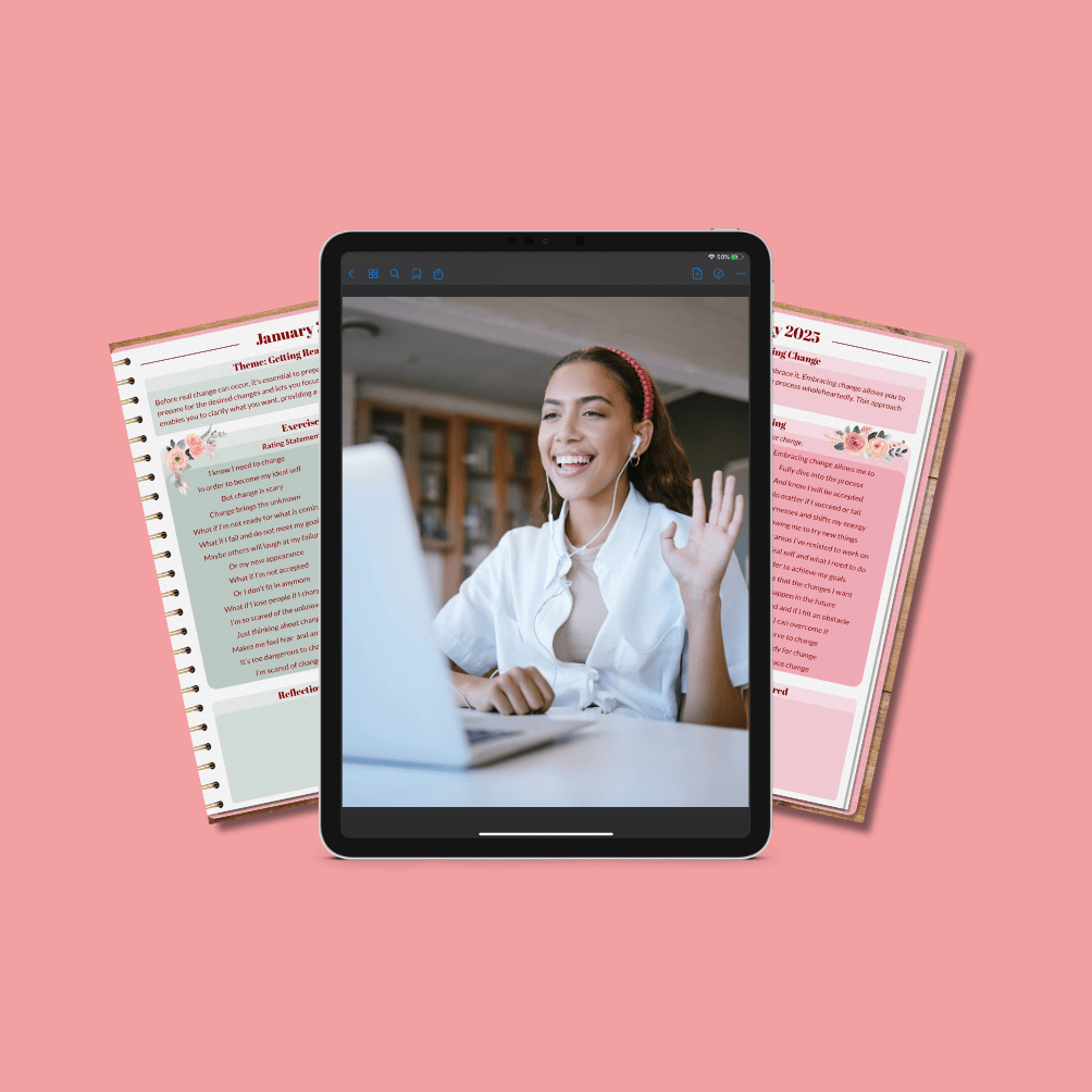 A woman waves during a video call on a tablet, with open planners or journals in the background, on a pink surface.