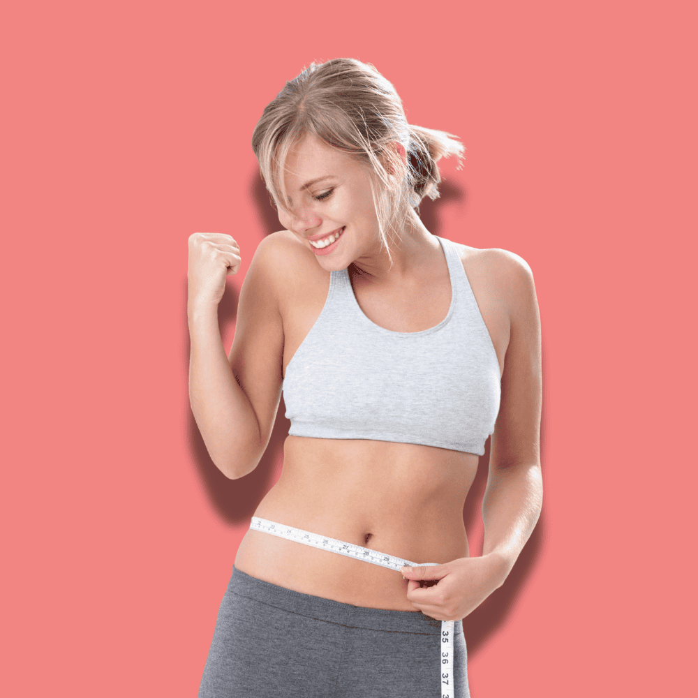 Woman in a gray sports bra and shorts celebrates, measuring her waist with a tape measure. She smiles, showing a fist in triumph. Pink background.