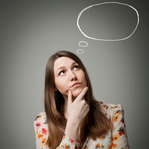 Woman with long hair in a floral shirt thinking, with a hand on her chin and a thought bubble drawn above her head.