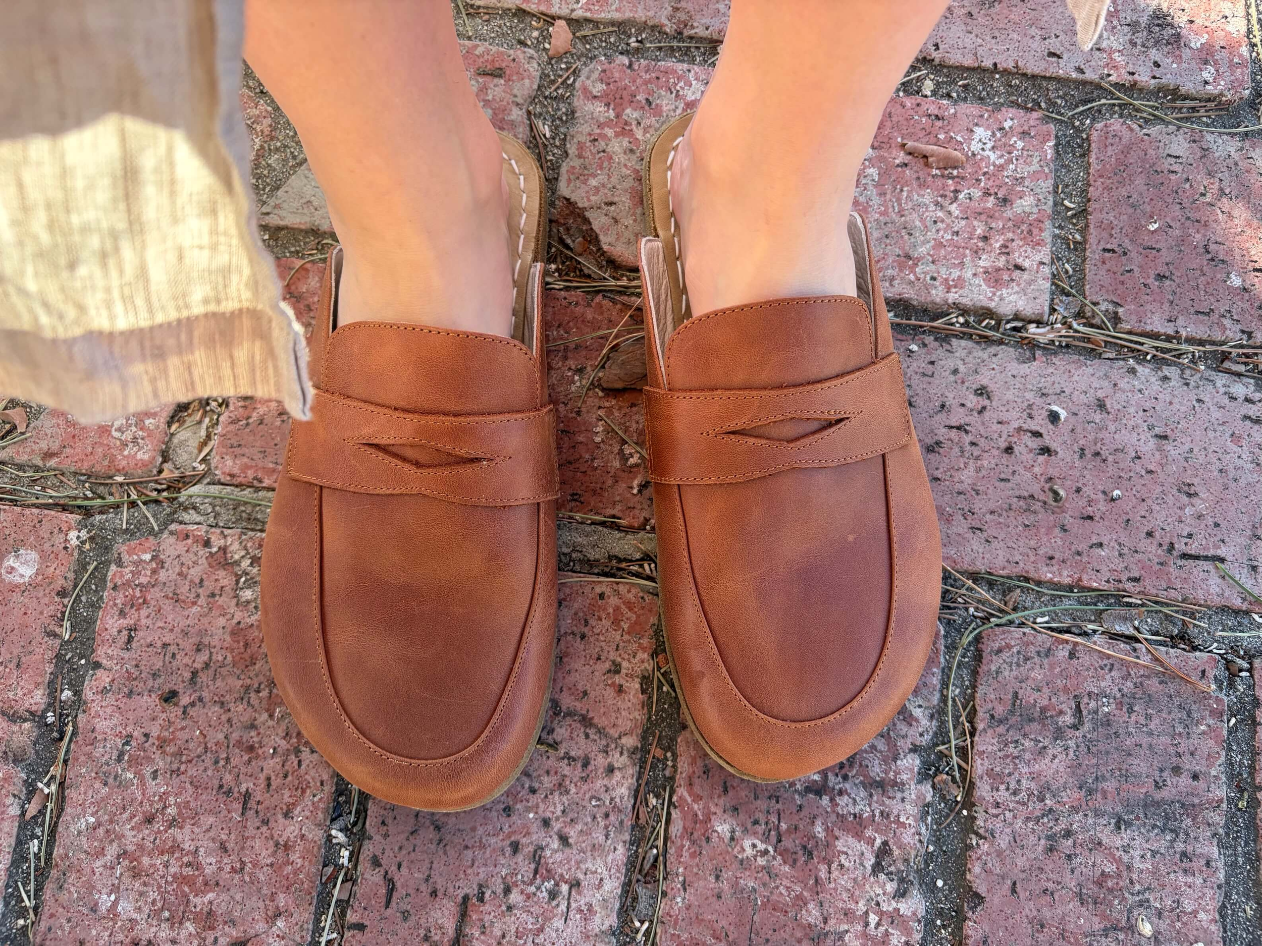 Woman wearing Earthing Harmony Grounding, Earthing and Barefoot Penny Clogs in Chesnut Brown