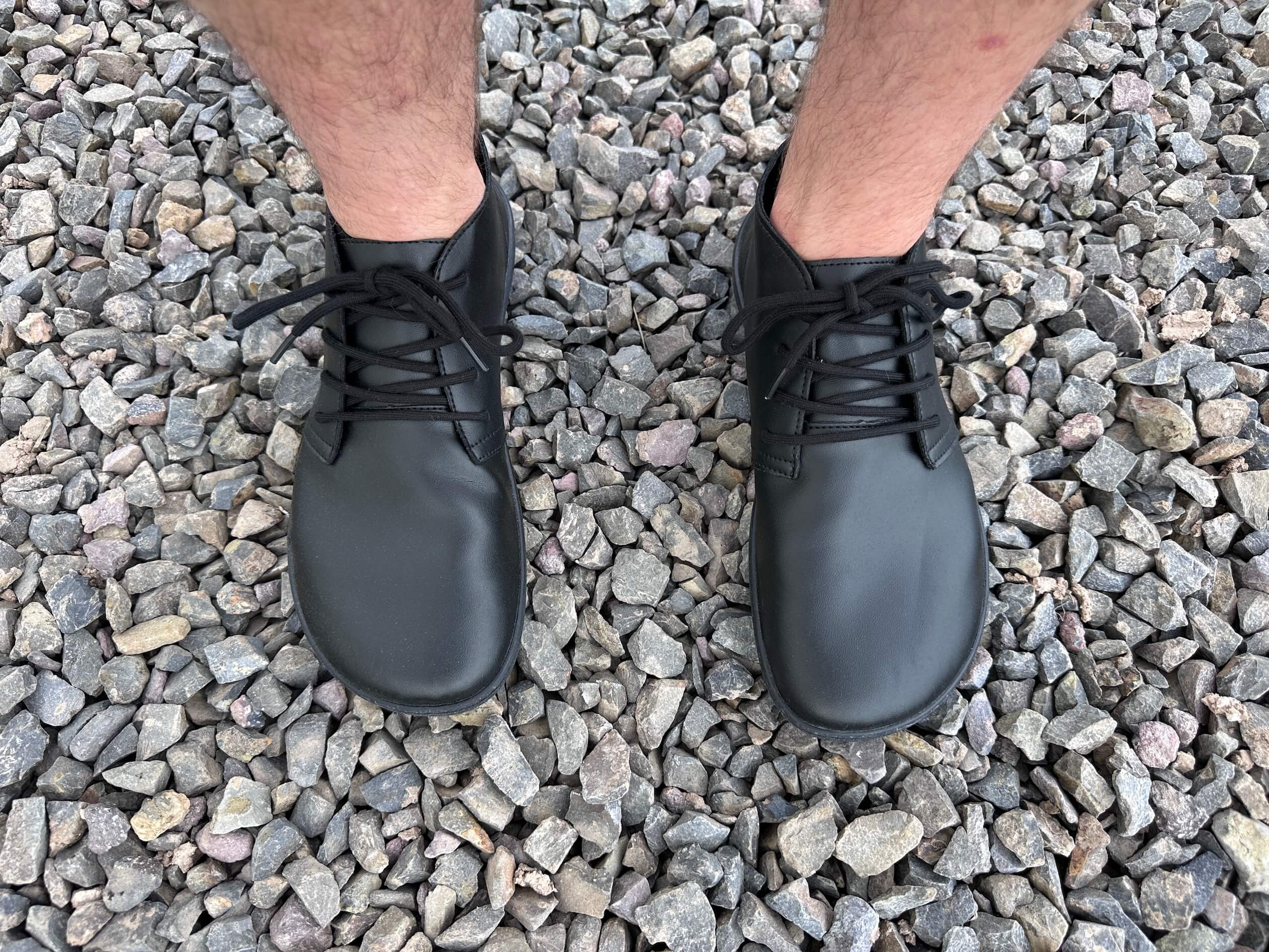 man standing on rocks wearing Saguaro Noble Ⅰ barefoot shoes