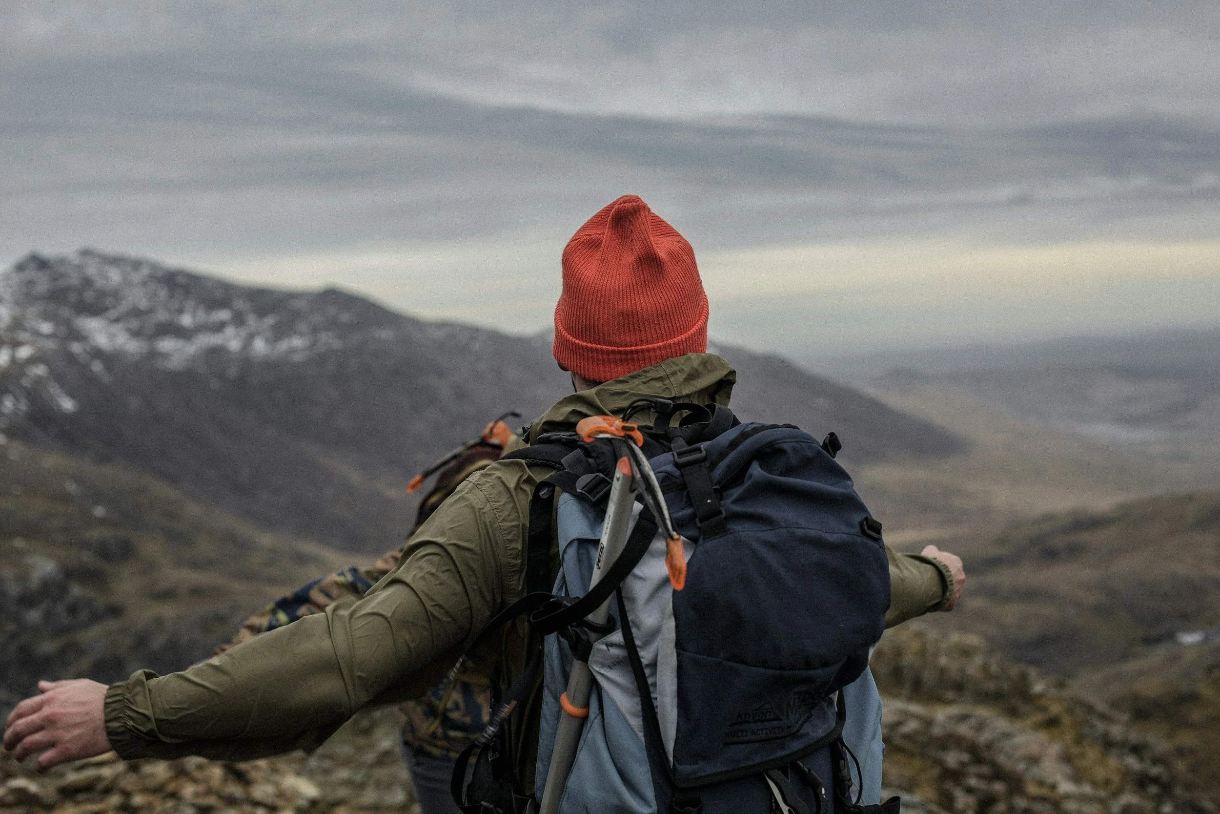 man hiking outdoors with his arms spread out wide
