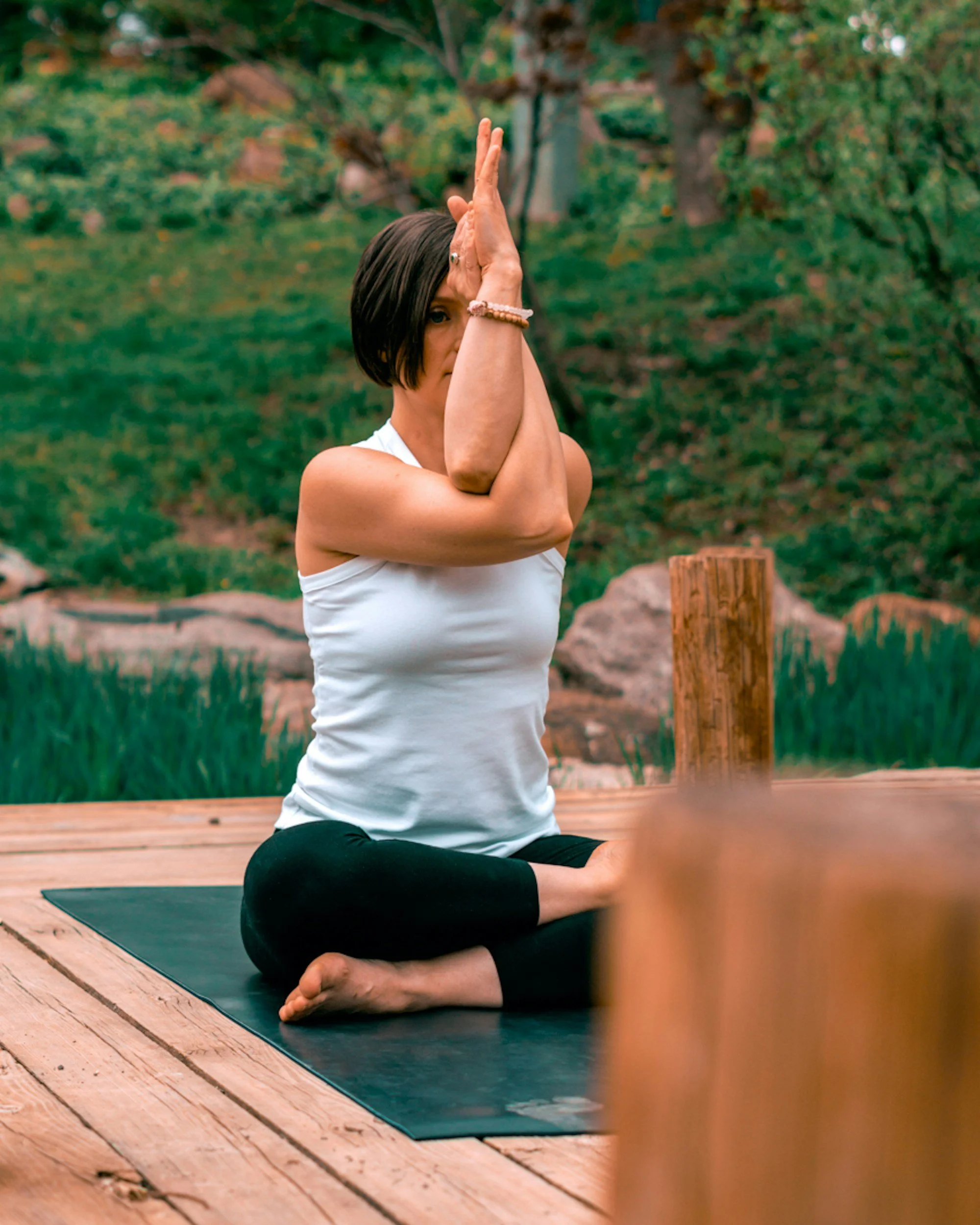 woman practicing yoga in her backyard wearing organic cotton yoga leggings