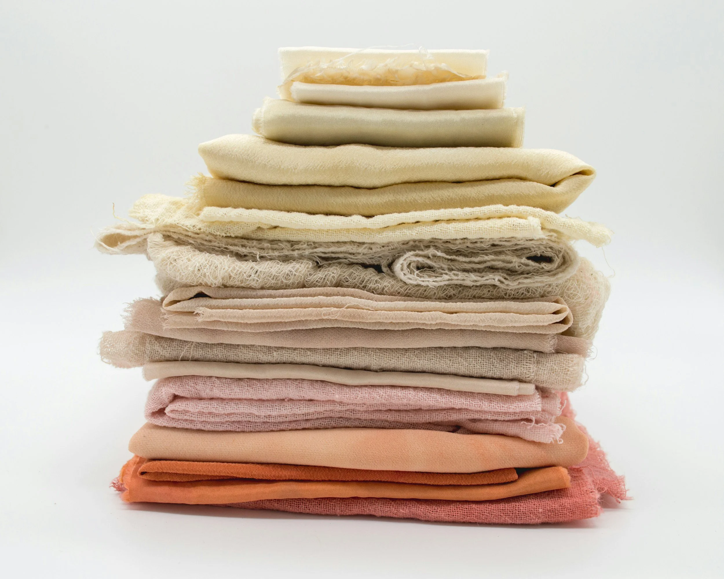 organic cotton fabrics folded and stacked on top of one another
