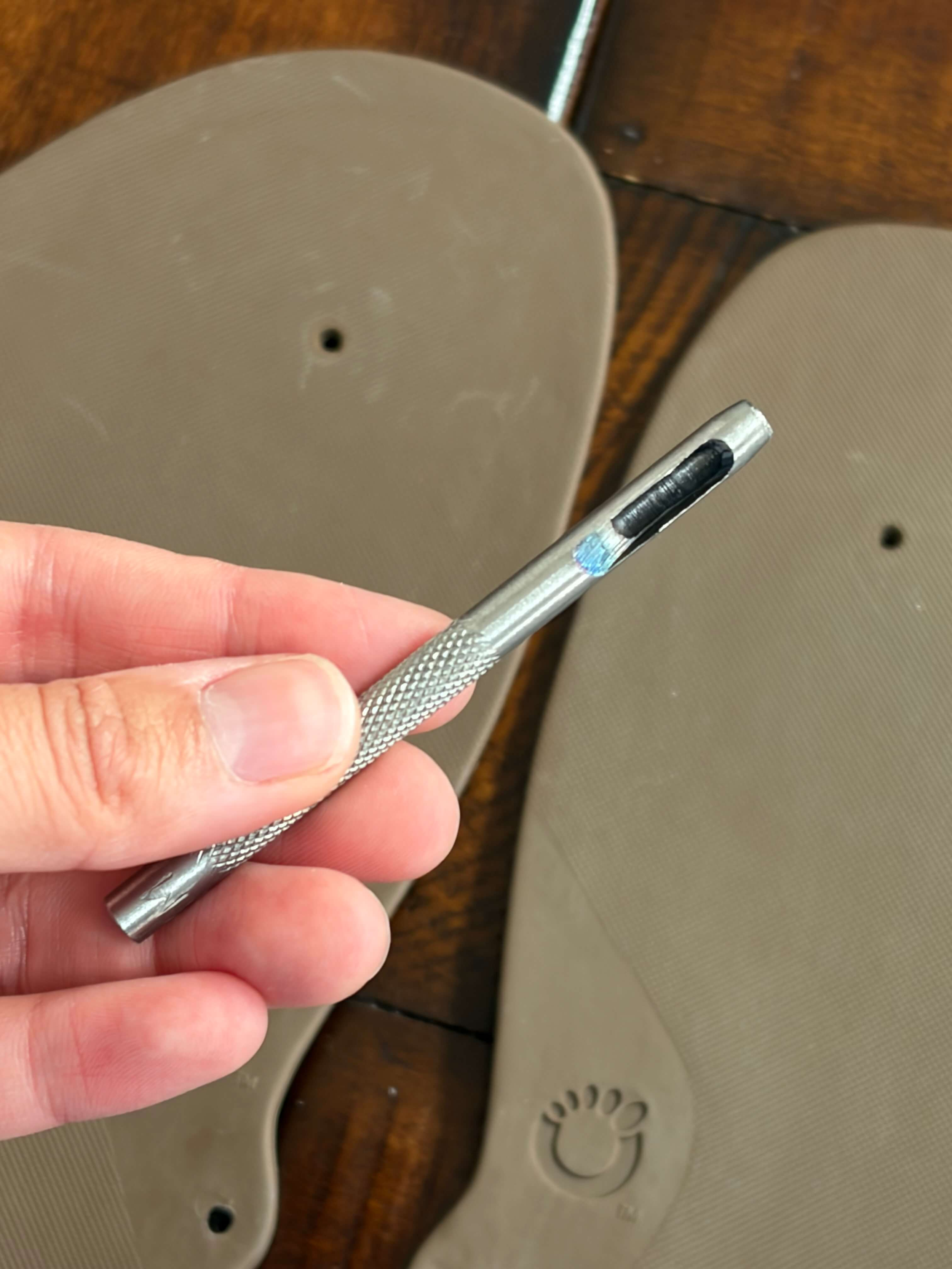 Xero Shoes Genesis DIY Sandal hole punch in use