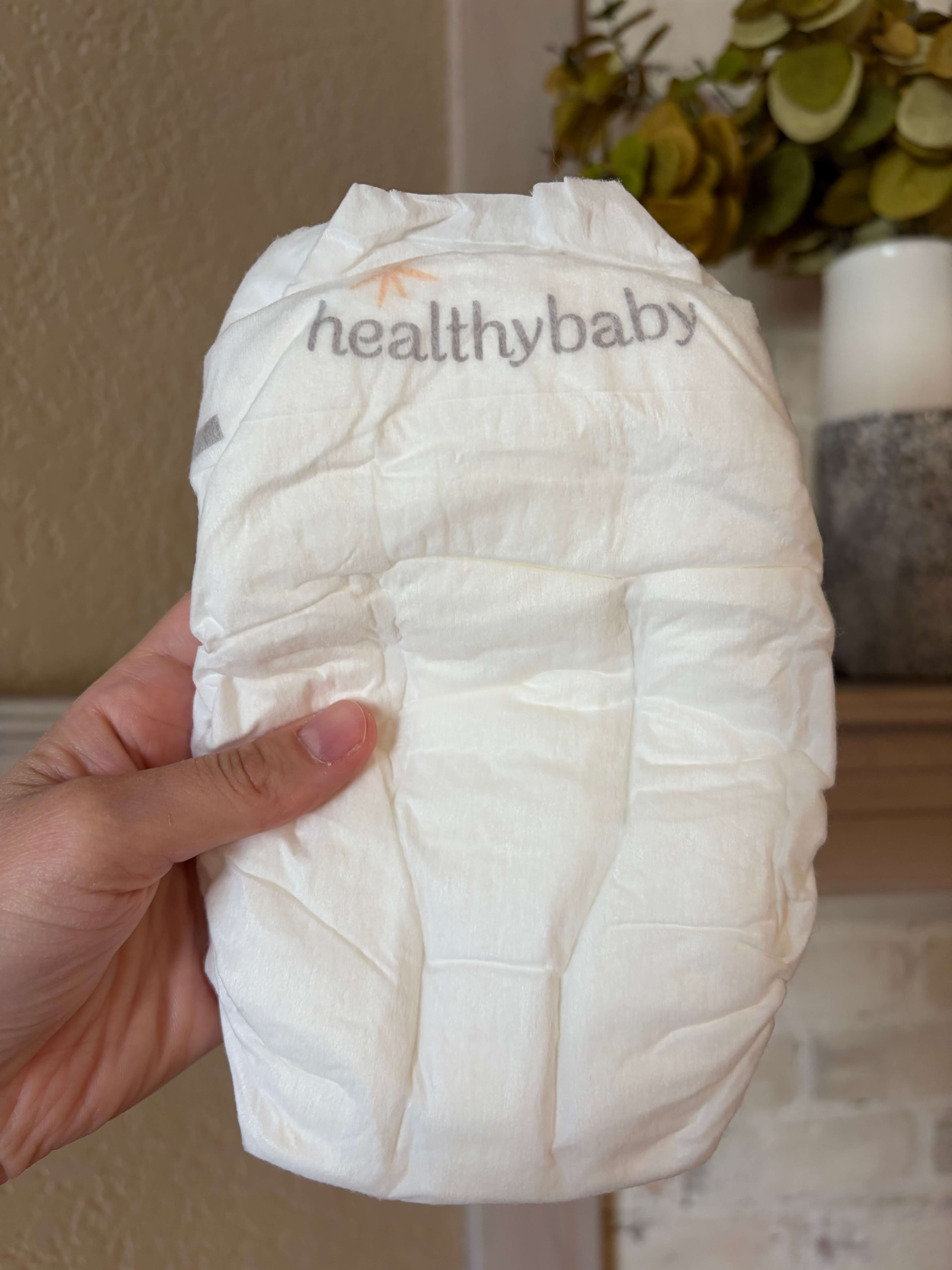 Mom holding a non-toxic healthybaby our diaper