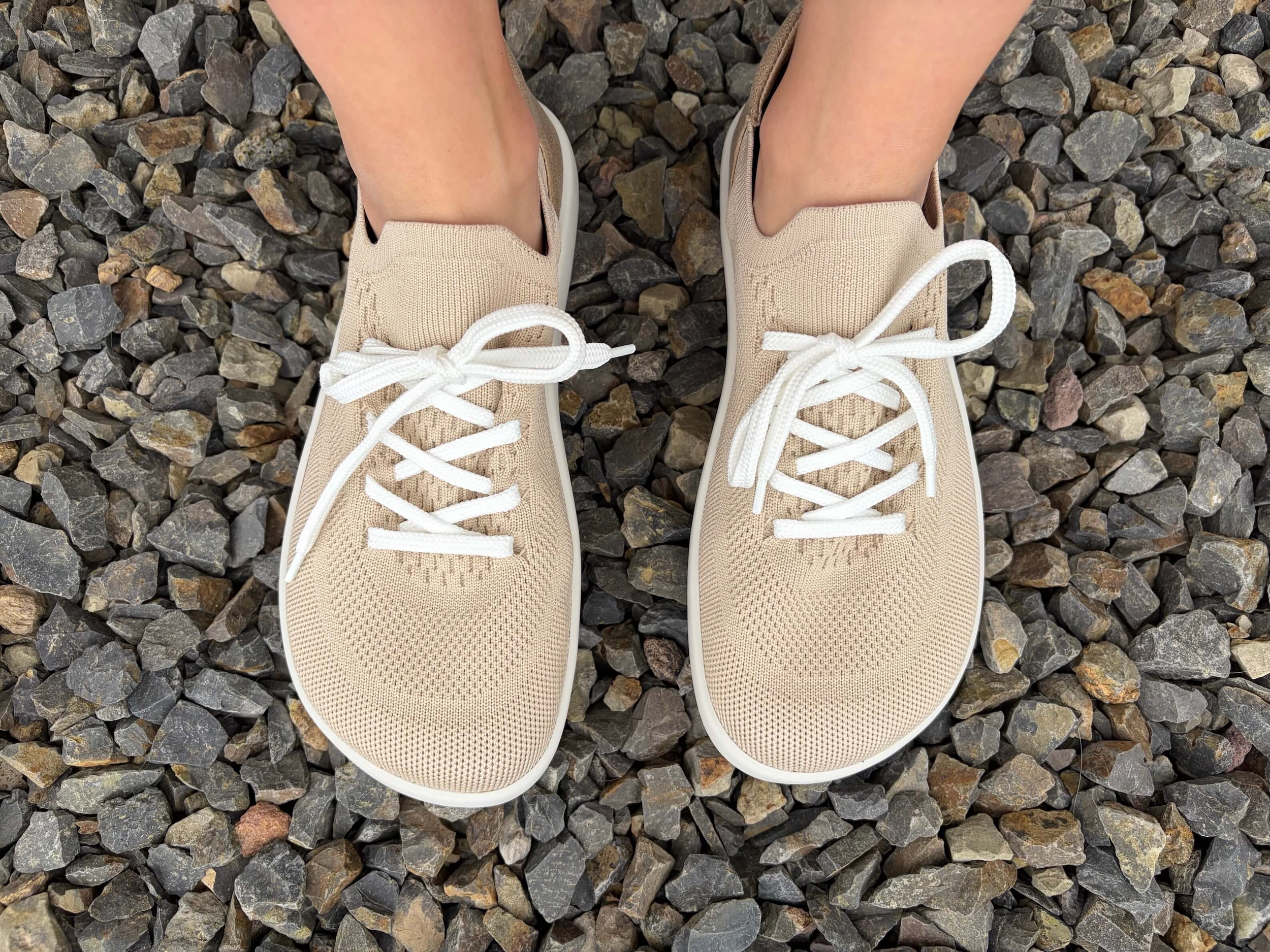 woman wearing Ahinsa Softy Barefoot Knit Sneakers standing on rocks