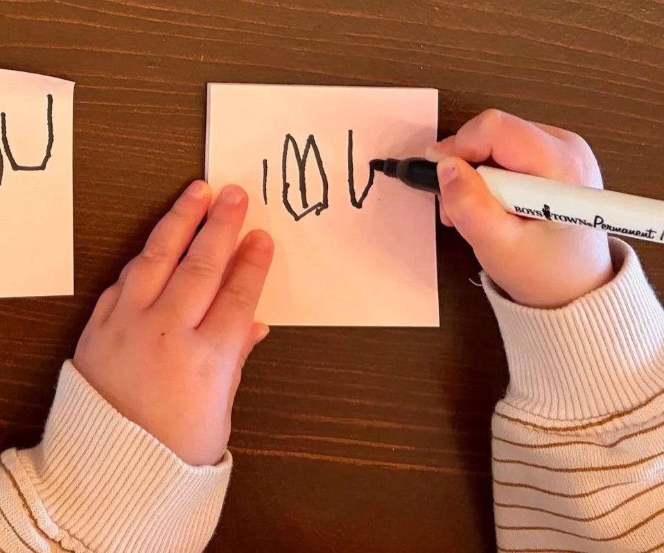 toddler writing "I love you"
