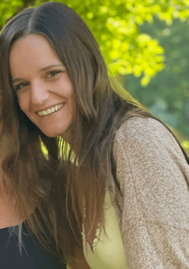 woman with natural brown hair while growing out her blonde highlights