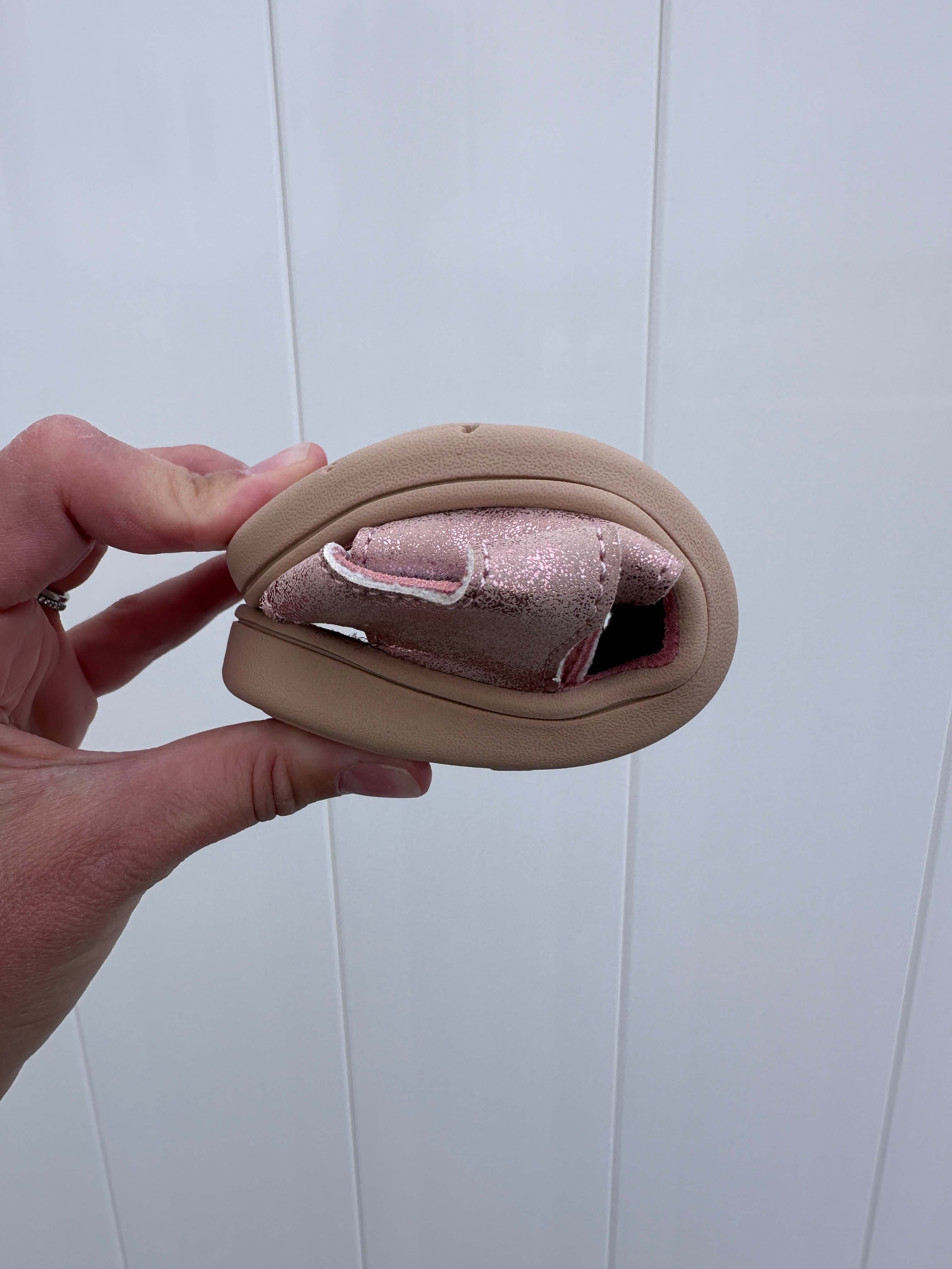 be lenka miami kids barefoot sandal being rolled to show the flexibile sole