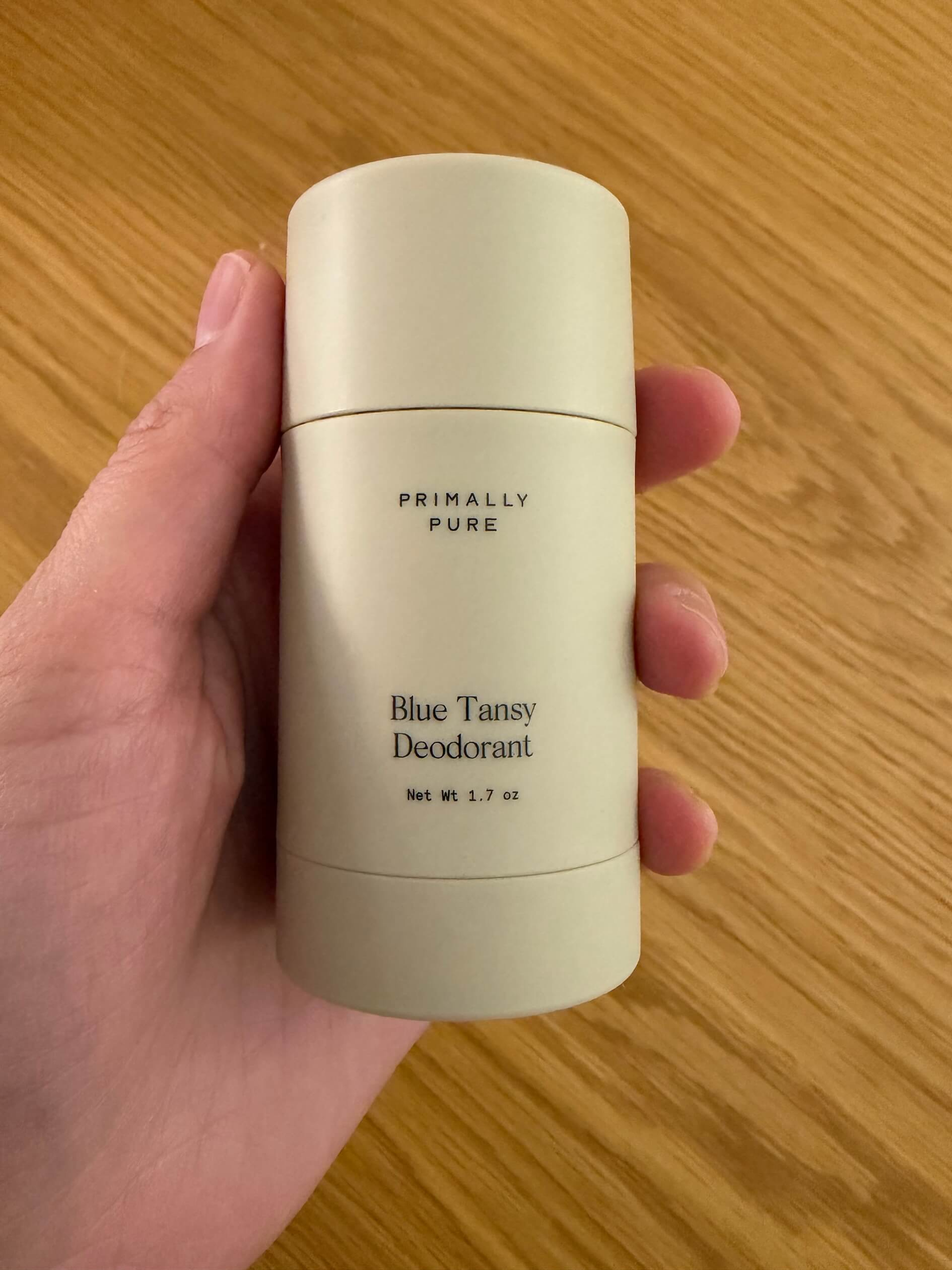 Woman holding Primaly pure blue tansy deodorant