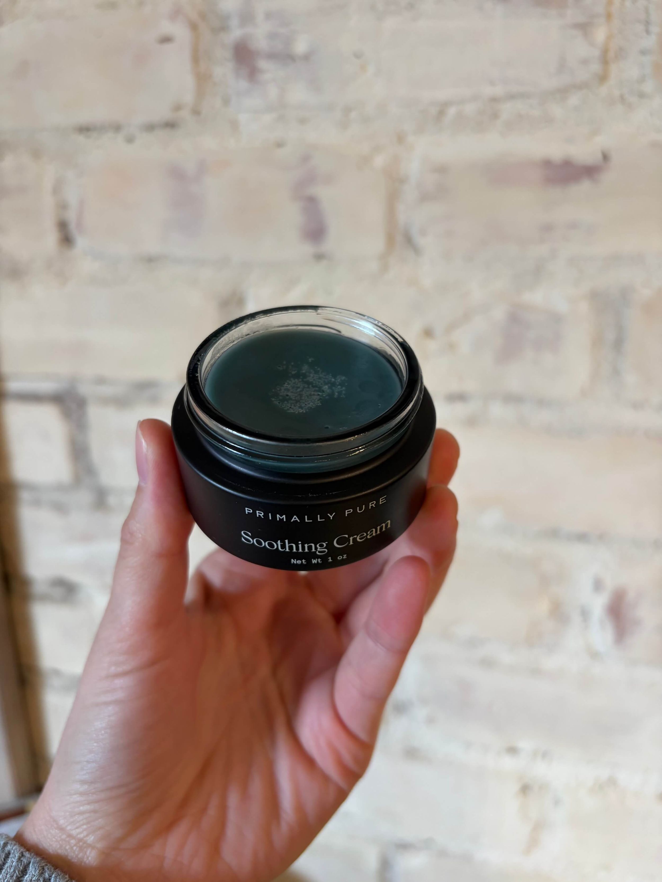 woman holding primally pure blue tansy soothing cream