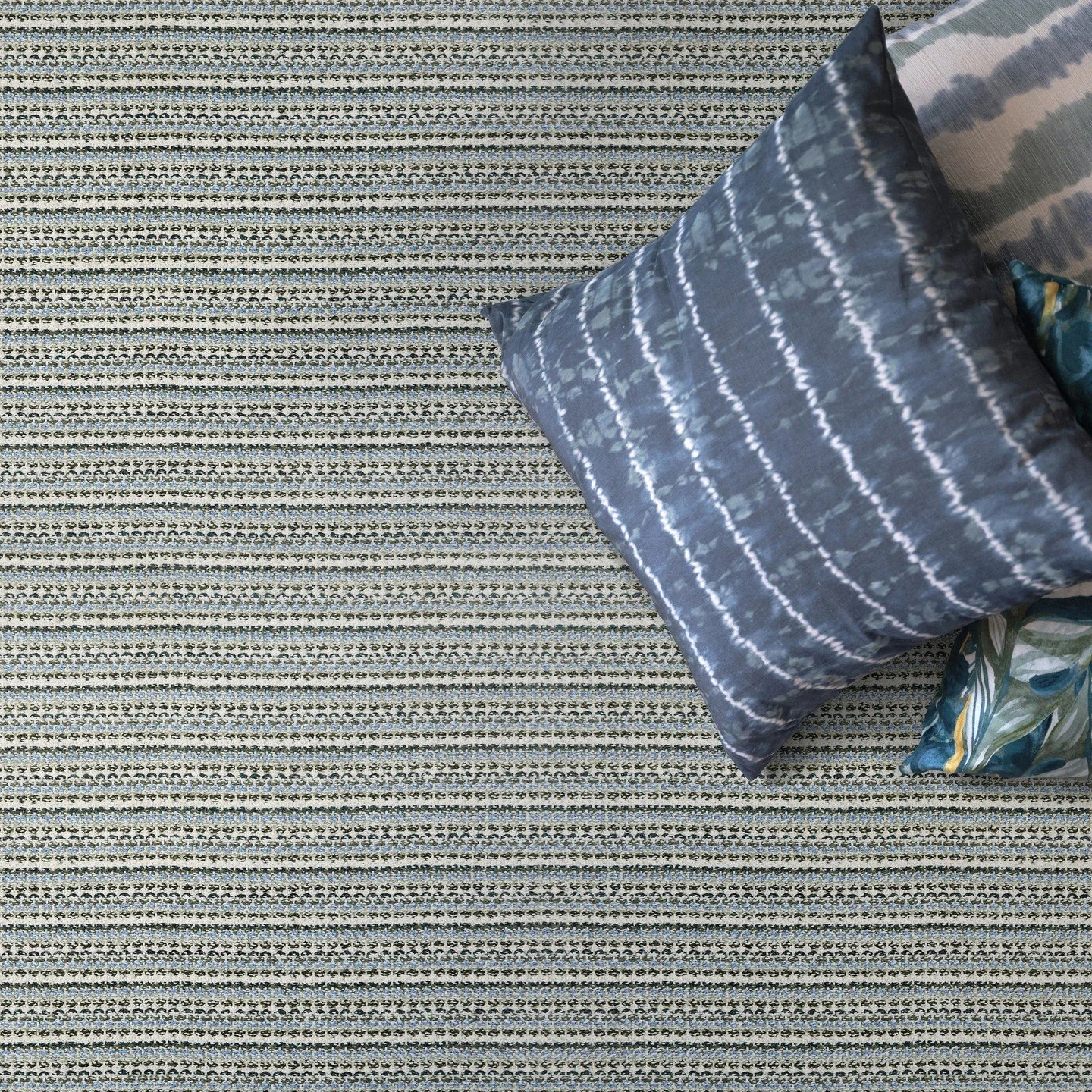 Kravet x Stanton style Leeward brings a refined touch to outdoor living with its small-scale horizontal stripe and subtle braid-like texture. Crafted from solution-dyed polypropylene, this multi-tonal carpet boasts a palette of 5-6 harmonious colors 
