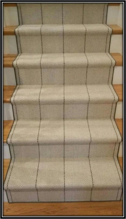 Carpeted staircase with a beige and black striped pattern, wood side rails