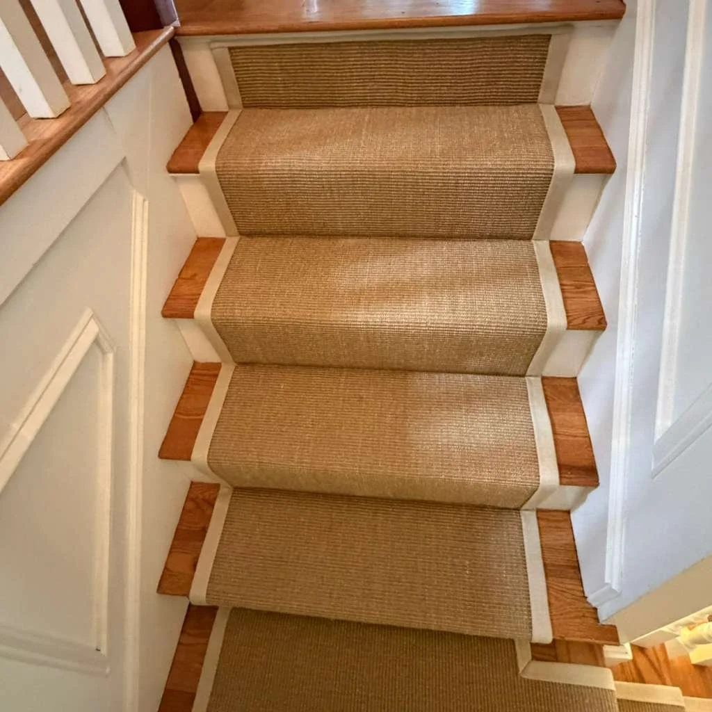 Top of Stair with sisal carpet and wide binding caped at the top riser