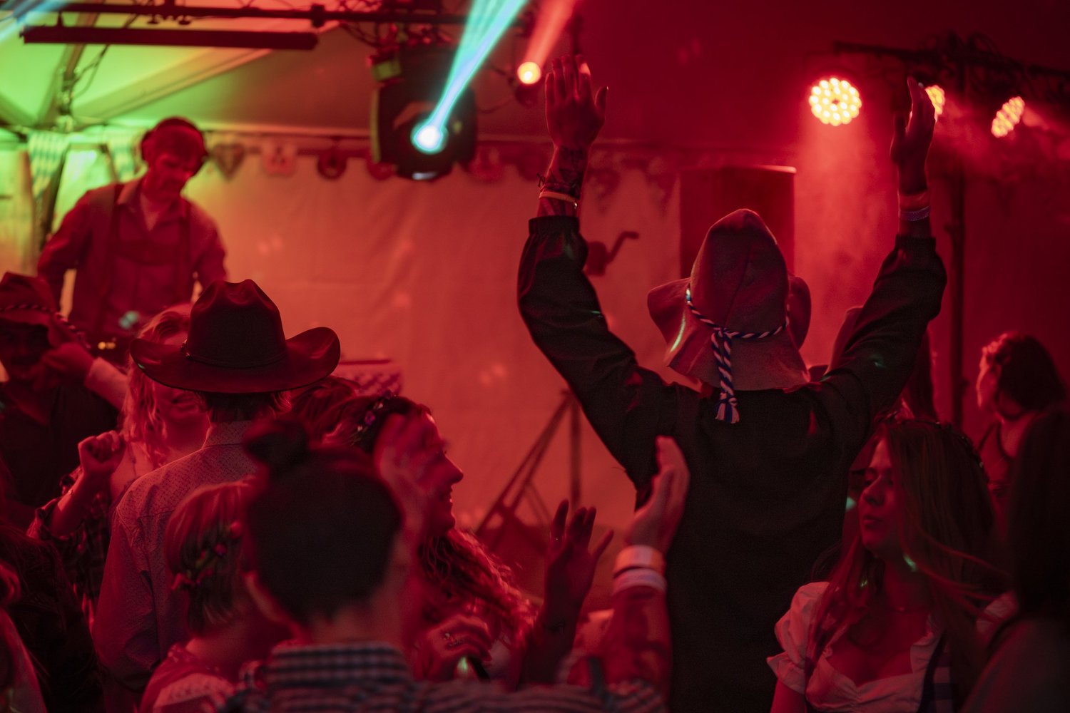 Crowd dancing under the lights in the Big Sky Oktoberfest tent
