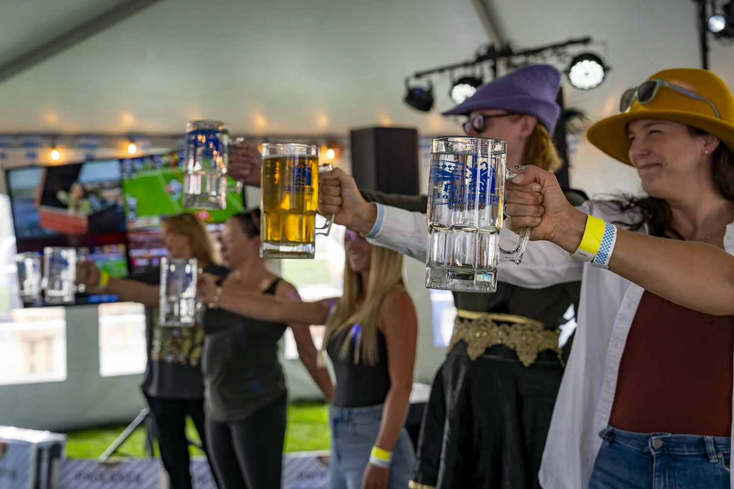 Saturday Stein Holding competitors with mugs extended