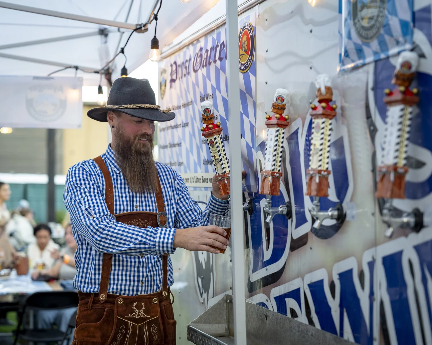 Pouring Paulaner from the Prost Garten taps