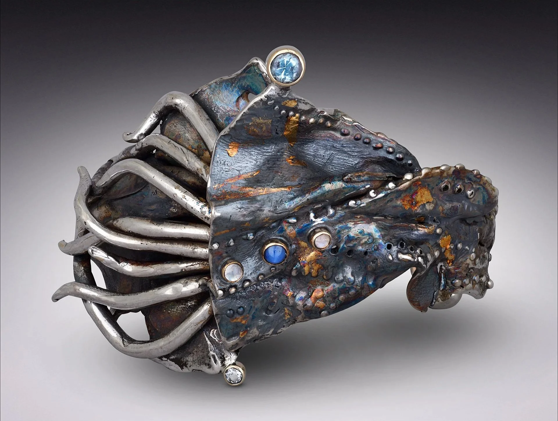 Traveller sterling silver with Kuem-boo heavy cuff.  Star Sapphire, Topaz, Labradorite.  $3000
