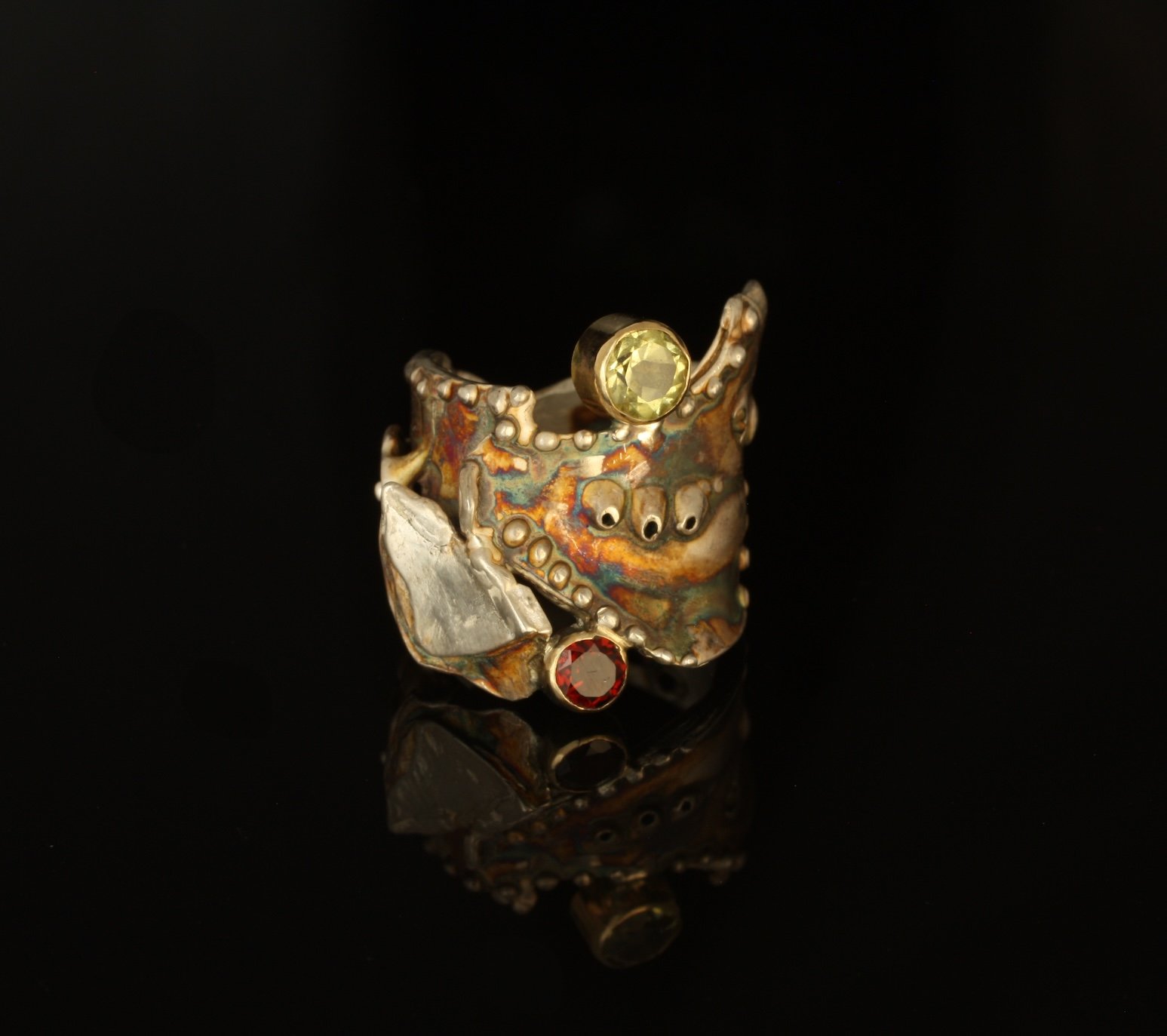 Coral Cave Ring Sterling Silver, 14k Gold, Kuem-boo. Peridot and Rhodolite. $750. 2025