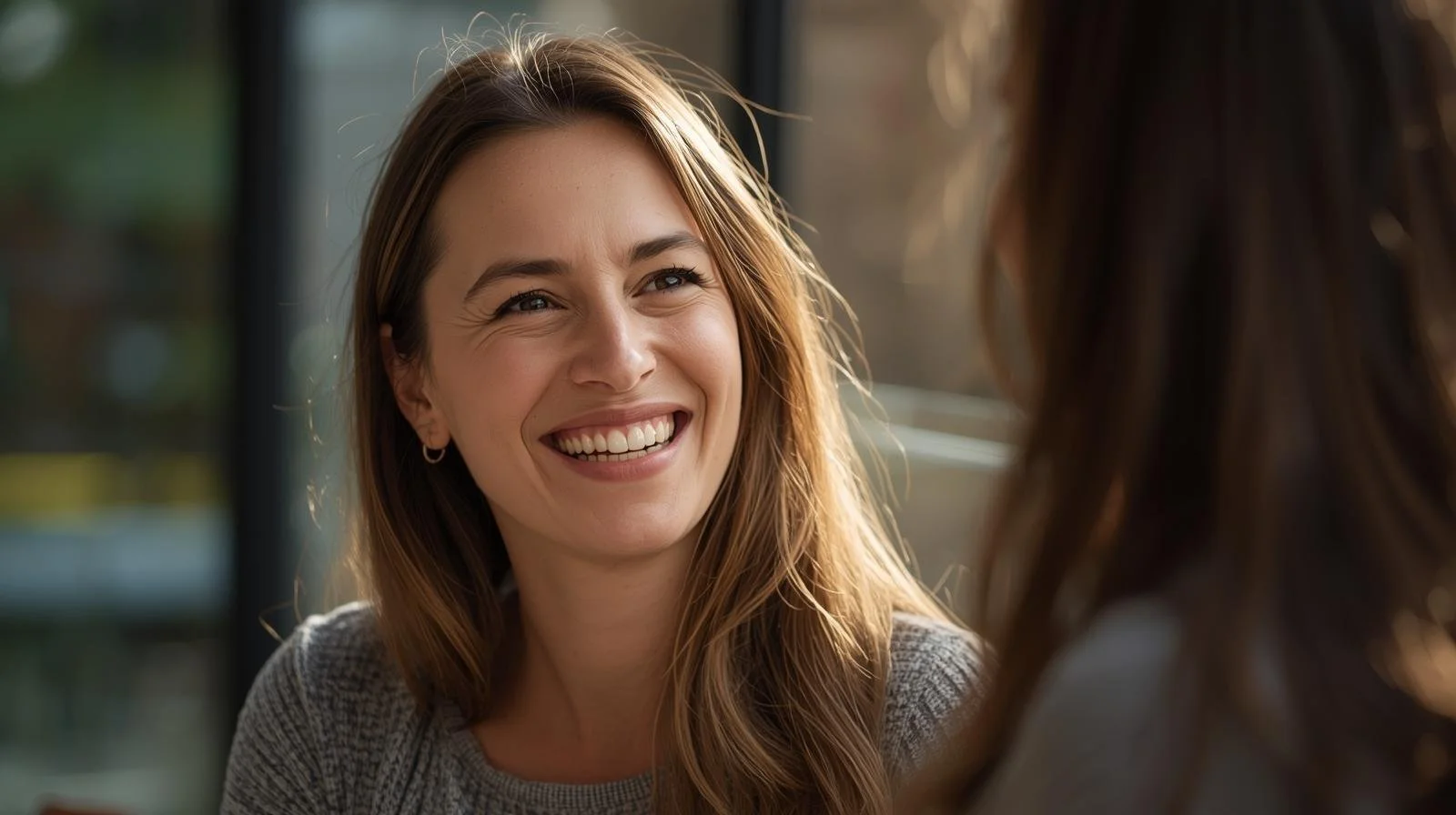 two women talking, one appears very happy.jpg