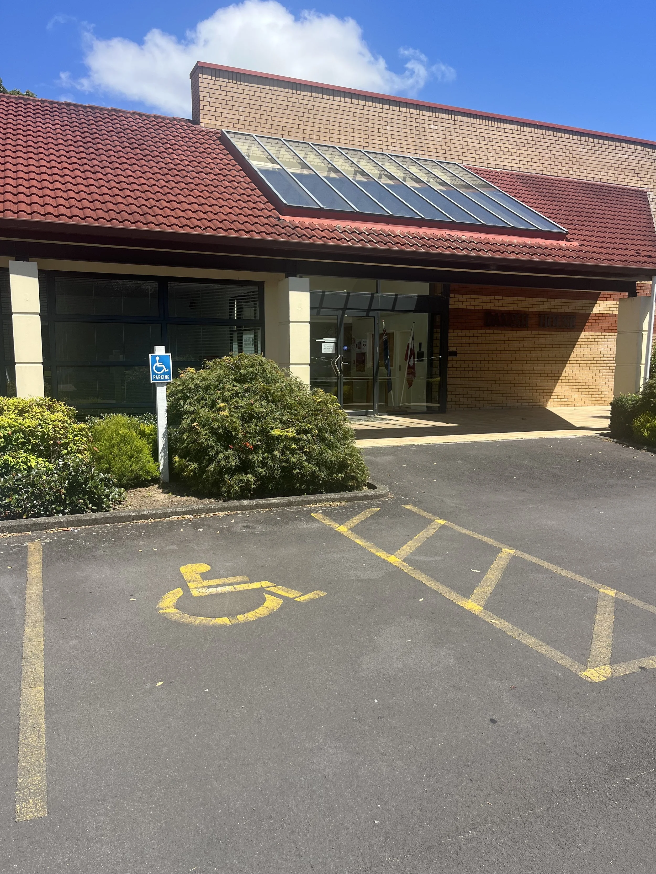Mobility park with a yellow brick building with a red roof in the background.