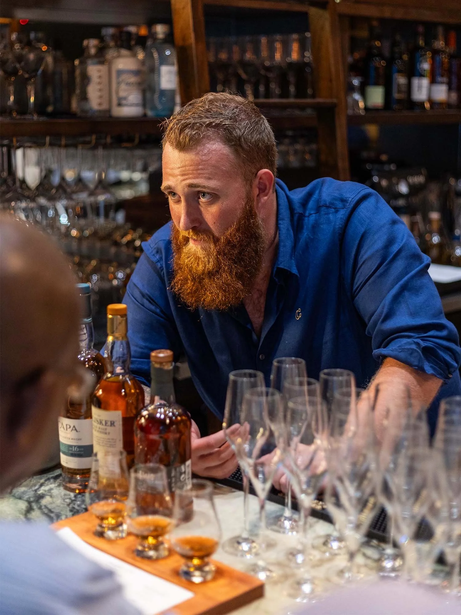 Guided whisky tasting experience with guests at Cask in Grand Cayman