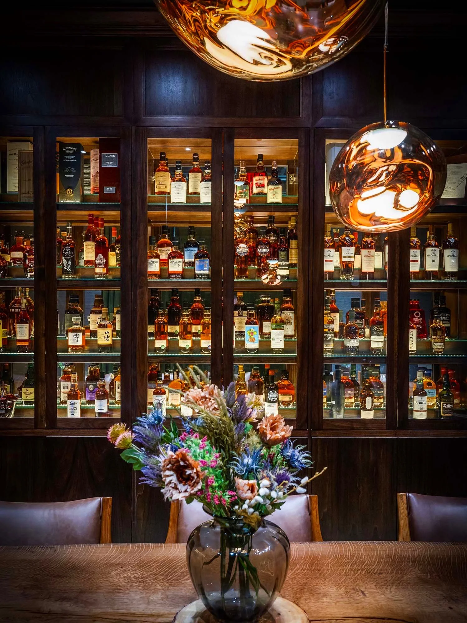Luxury whisky bar interior with extensive bottle collection at Cask in Grand Cayman