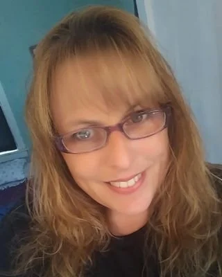 Close-up of Colleen Port, LGSW, who has blonde hair, glasses and a friendly smile.