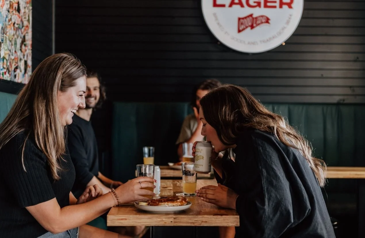 Good-Land-Brewing-people-sitting-at-tables-laughing-while-drinking-beer-inside-brewery_5592b0210488f5a8190c72fa41115a6f.jpeg