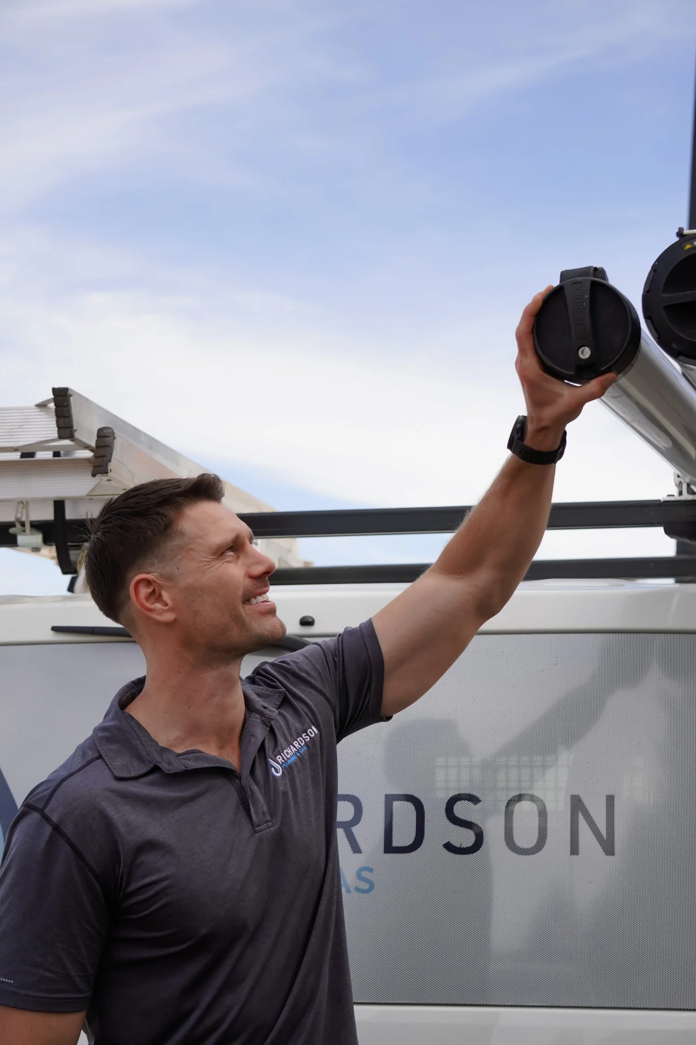 Local Adelaide plumber Ryan Richardson with his plumbing van