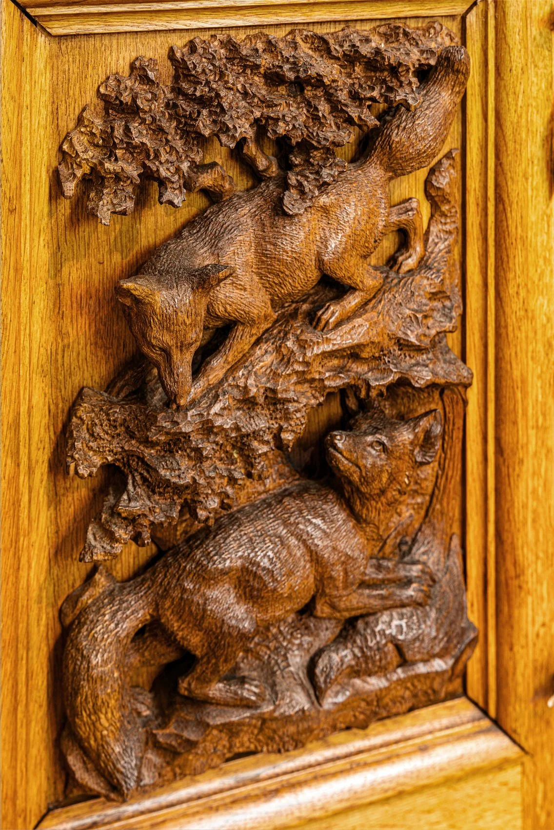 Lower door panel carved in high relief with foxes in woodland, Black Forest Jagdschrank, late 19th century