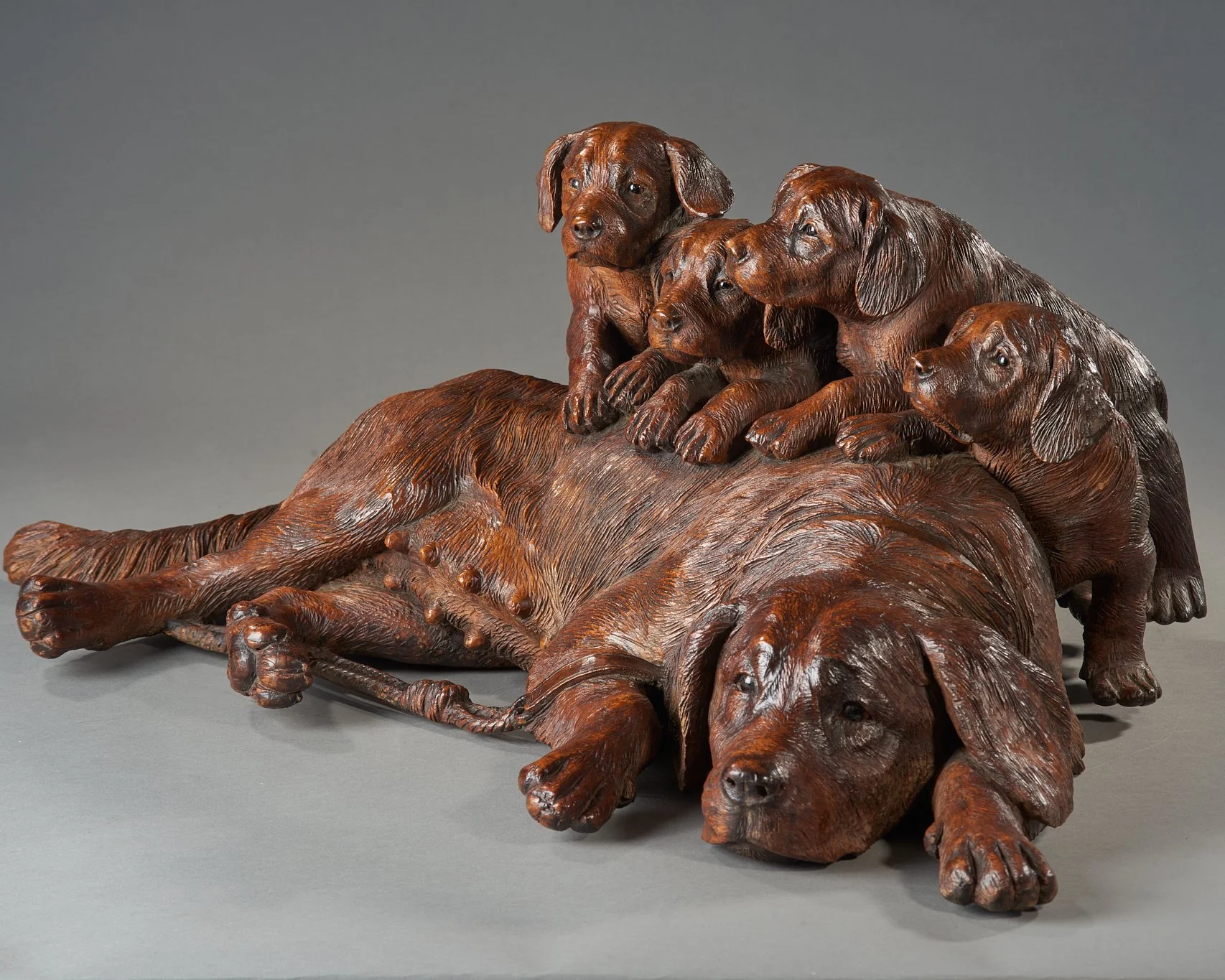 Swiss Black Forest carved walnut group of a dog and four puppies, Brienz, circa 1880. Illustrated in Swiss Carvings: The Art of the Black Forest, 1820–1940, plate 00.
