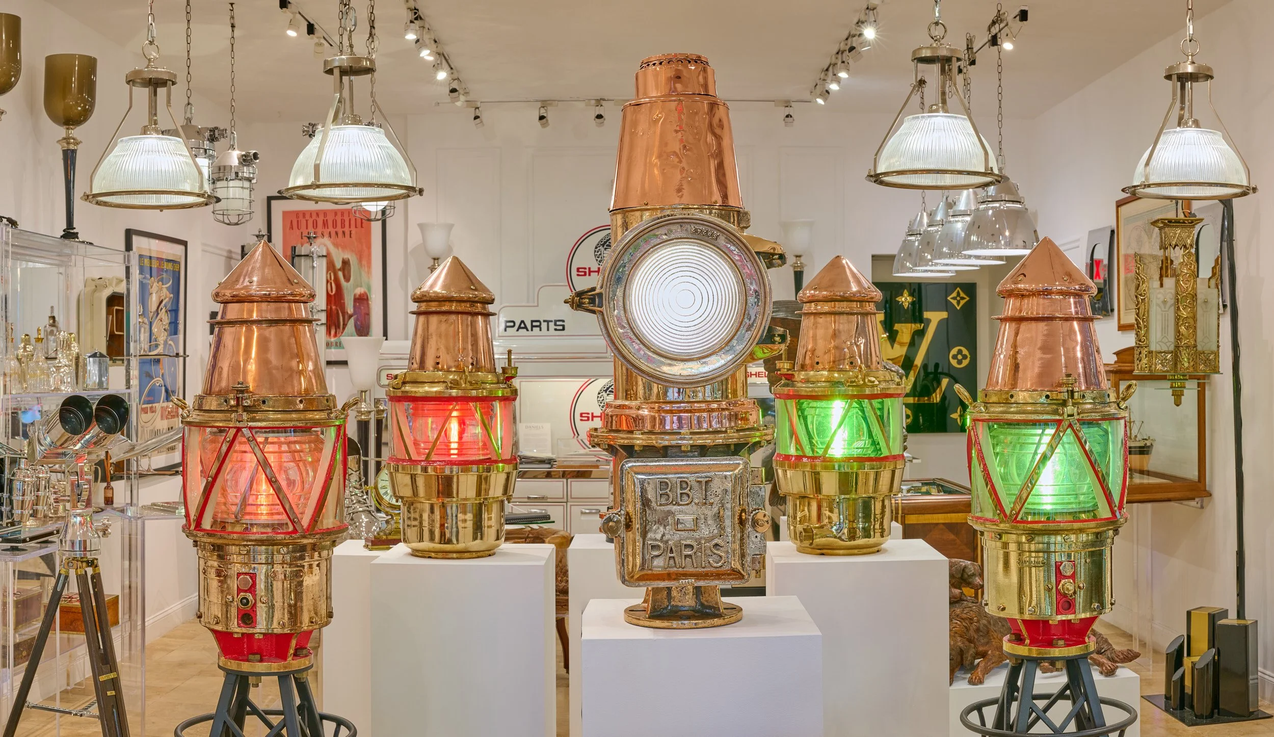 Antique maritime navigation lights gallery display, B.B.T. Paris leading light and Fresnel harbor beacon pairs — Daniels Antiques