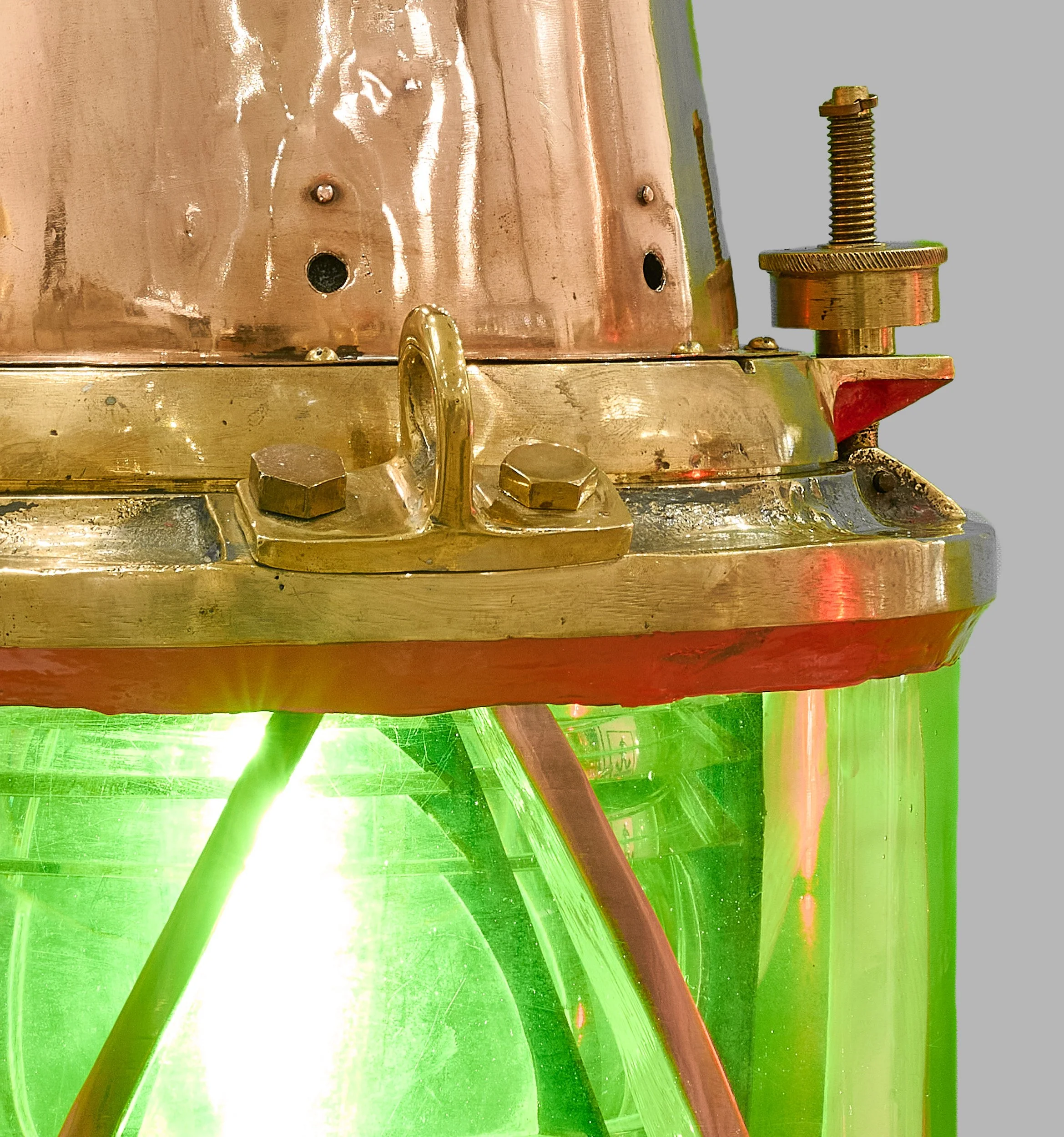 Green Fresnel lens, copper cowl and brass collar of antique harbor beacon — Daniels Antiques