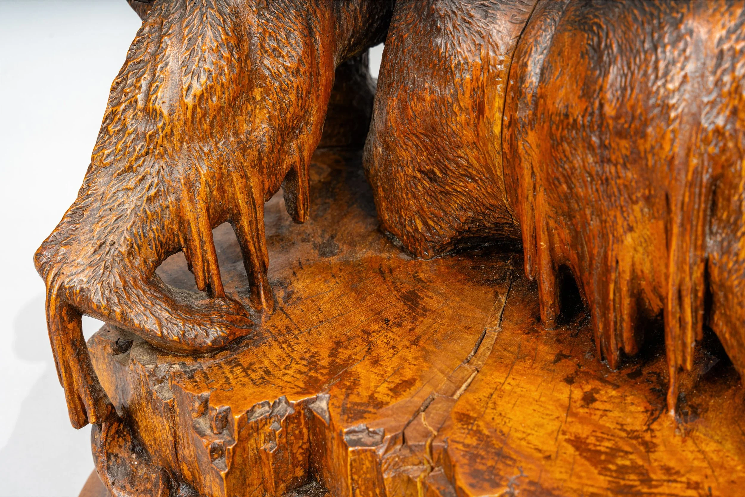 Detail of carved bear claws and fractured ice floe base, Swiss Black Forest walnut bear group, Brienz late 19th century