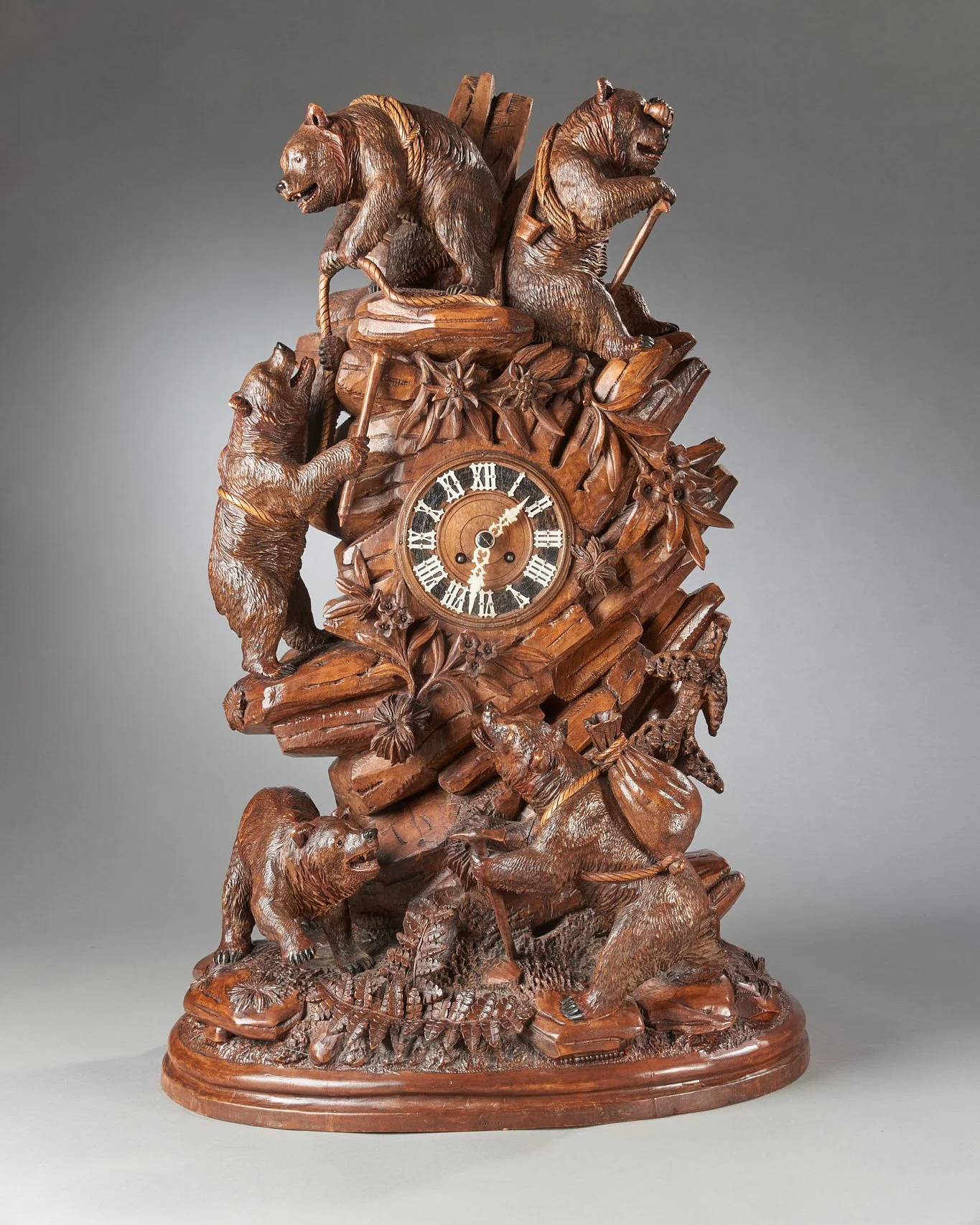 Swiss Black Forest carved walnut mountaineering bear clock illustrated in Swiss Carvings — Daniels Antiques