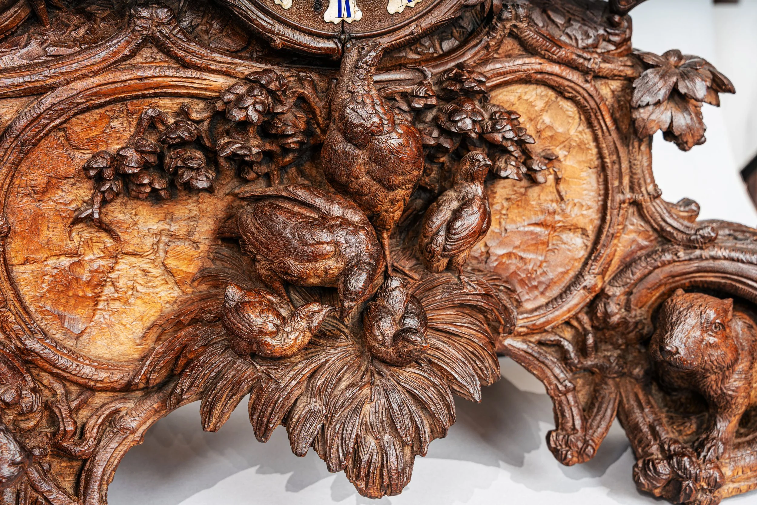 Base detail with partridge and game birds, Swiss Black Forest hunter clock signed J. Huggler, Brienz