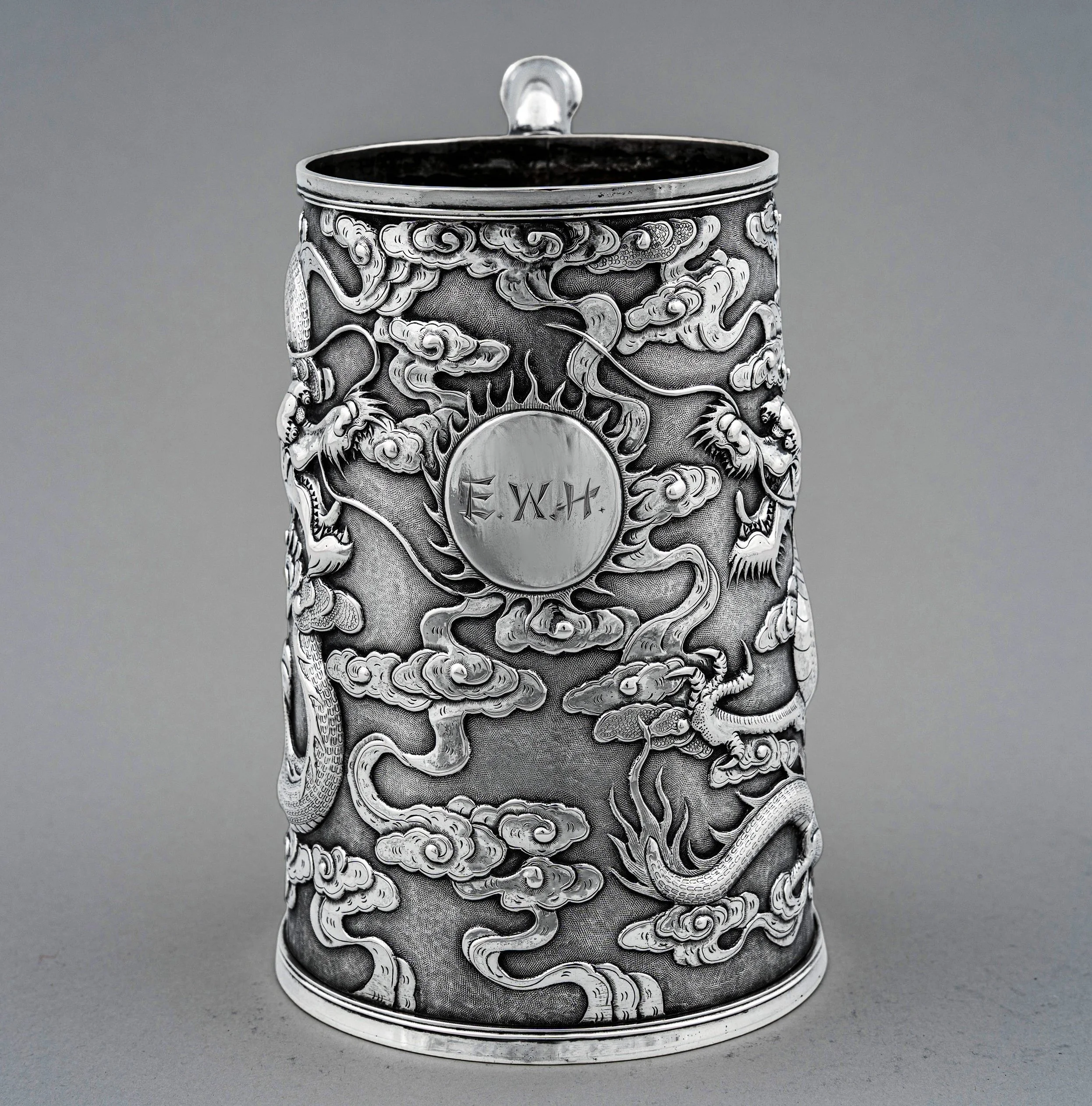 Chinese export silver tankard, Wang Hing, detail of tianlong dragons chasing the flaming pearl of wisdom — Daniels Antiques.