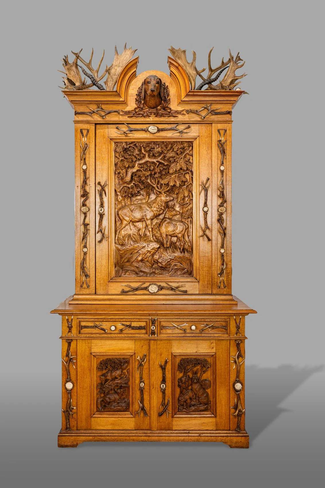 Black Forest antler-mounted hunting cabinet Jagdschrank, full view showing antler columns and lower case, late 19th century